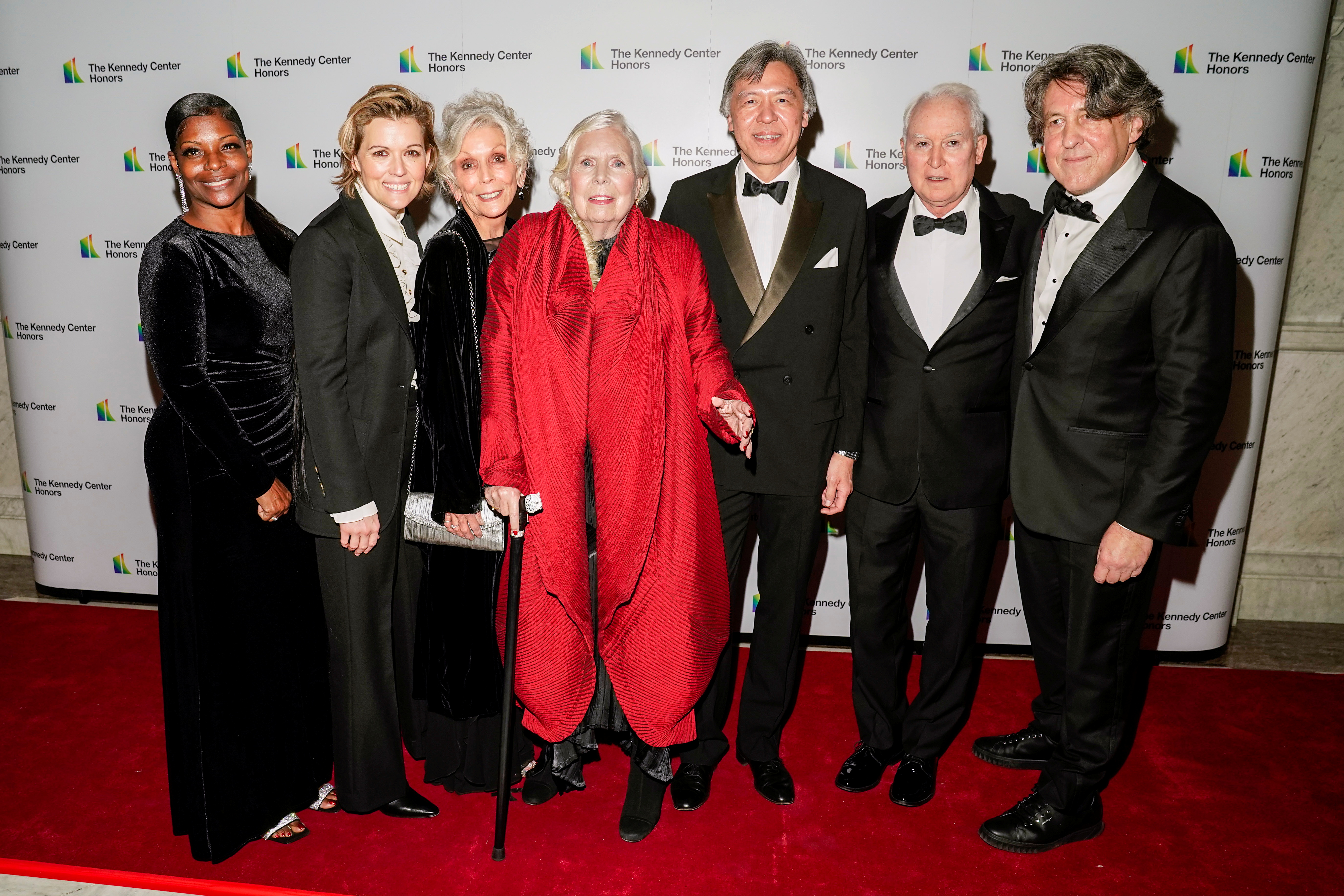 Singer-songwriter Joni Mitchell poses on the red carpet with friends and family as she attends the 44th Kennedy Center Honors Medallion Ceremony at the Library of Congress in Washington, D.C., U.S., December 4, 2021. REUTERS/Ken Cedeno