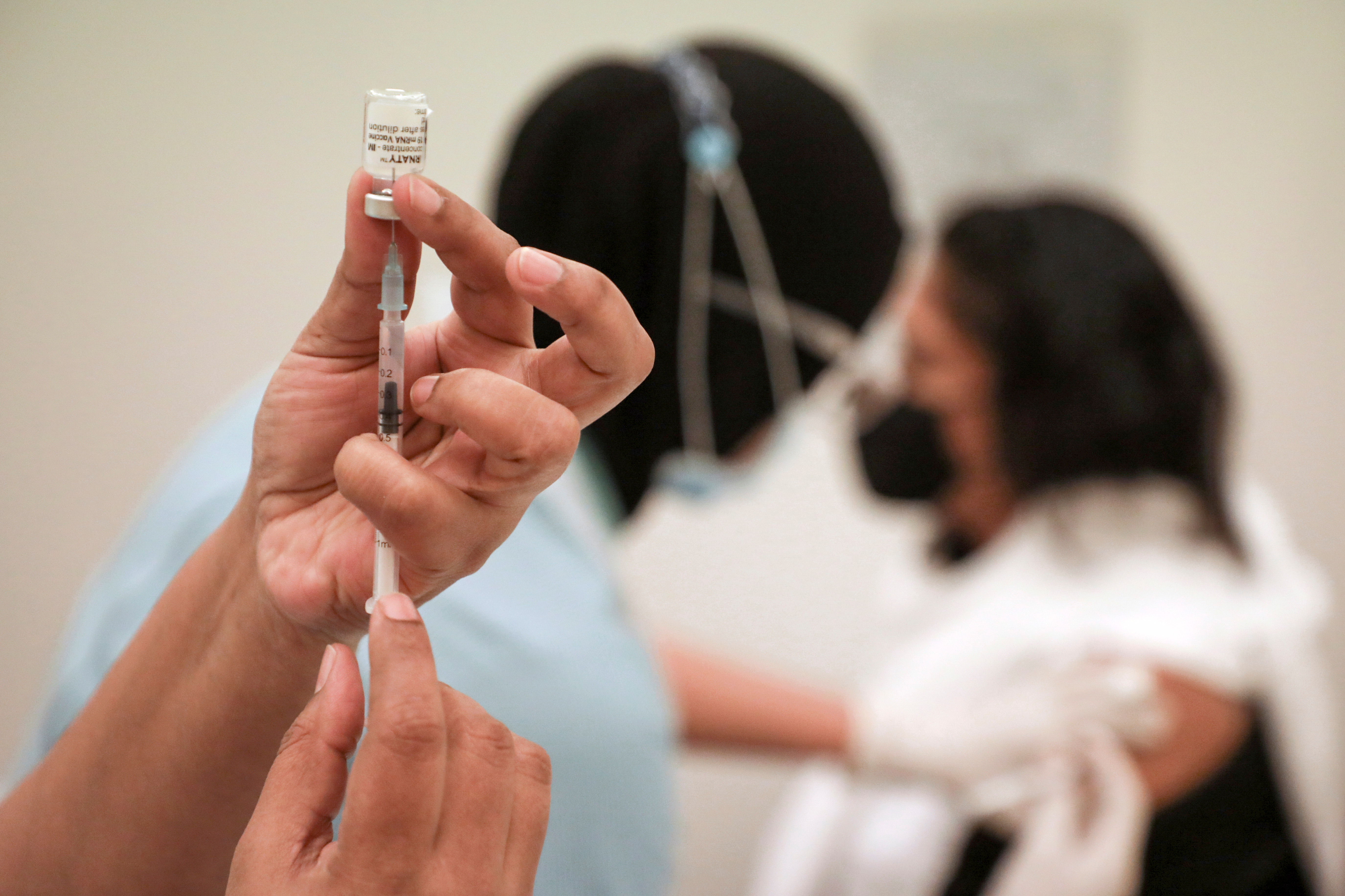 A medical worker prepares a dose of a vaccine for the coronavirus disease (COVID-19), at a vaccination centre in Sunway Medical Centre, in Subang Jaya