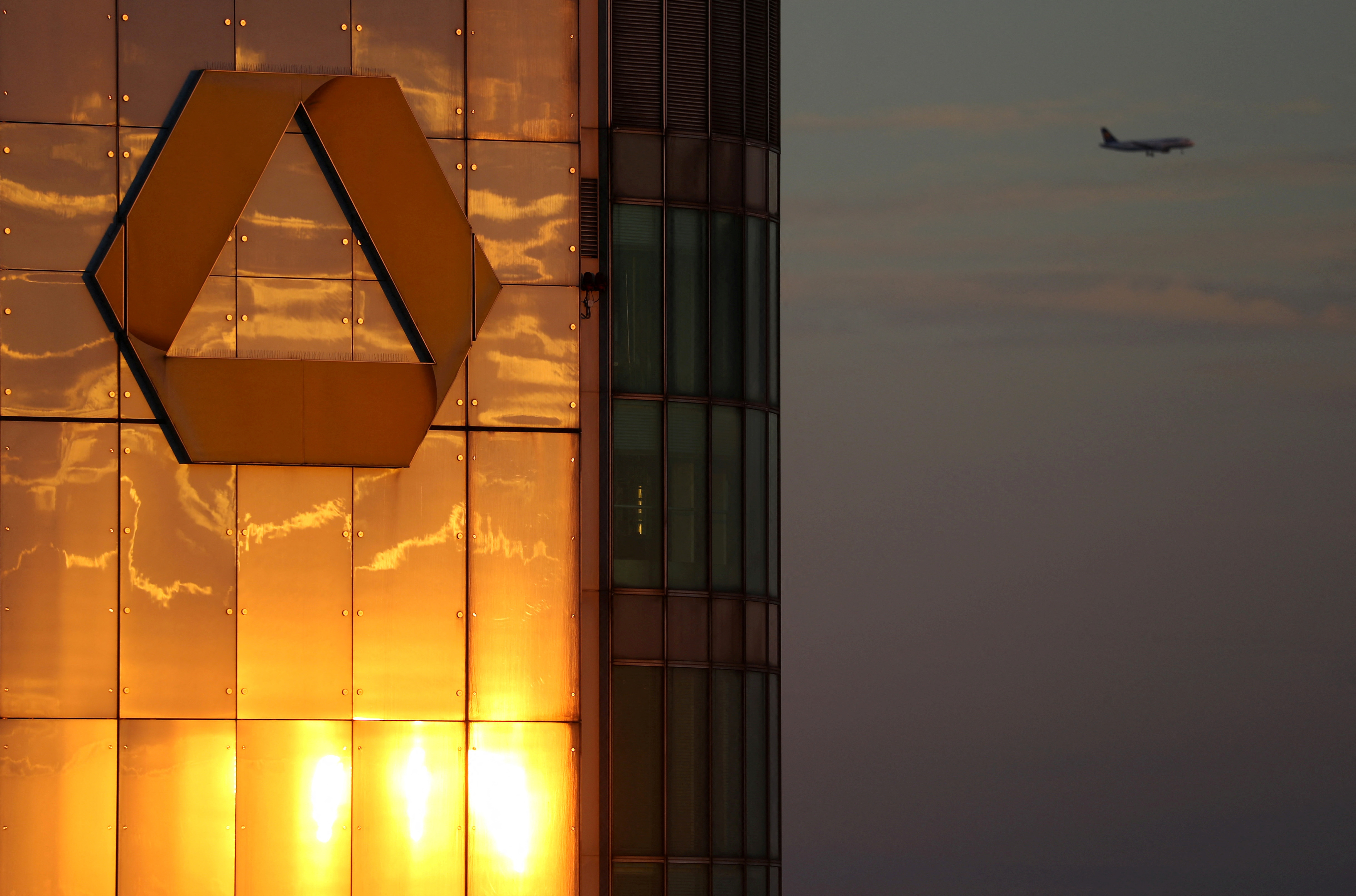 The logo of Germany's Commerzbank is seen in the late evening sun on top of its headquarters in Frankfurt