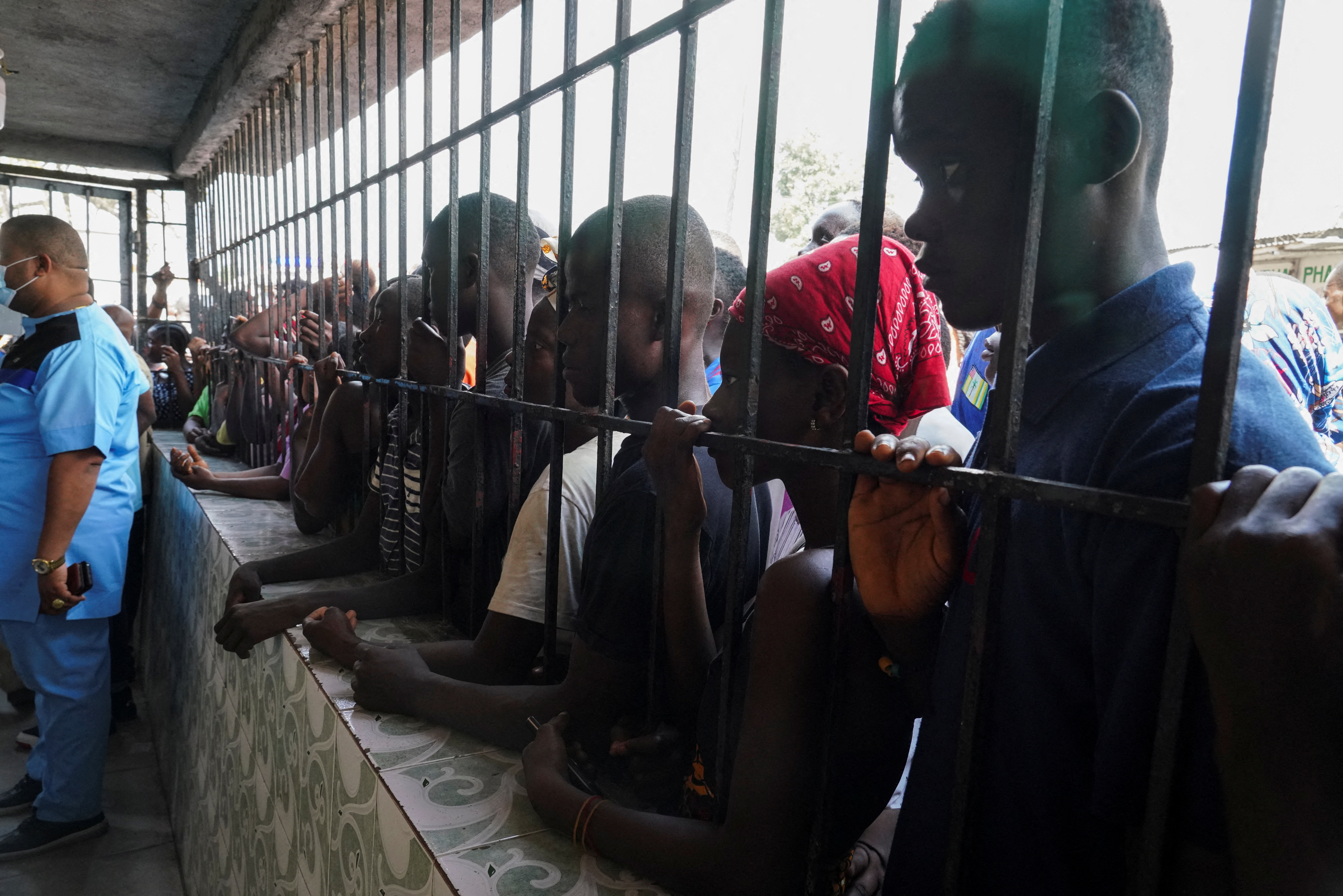 People gather outside the hospital after a stampede at a church gathering killed 29 people in Monrovia