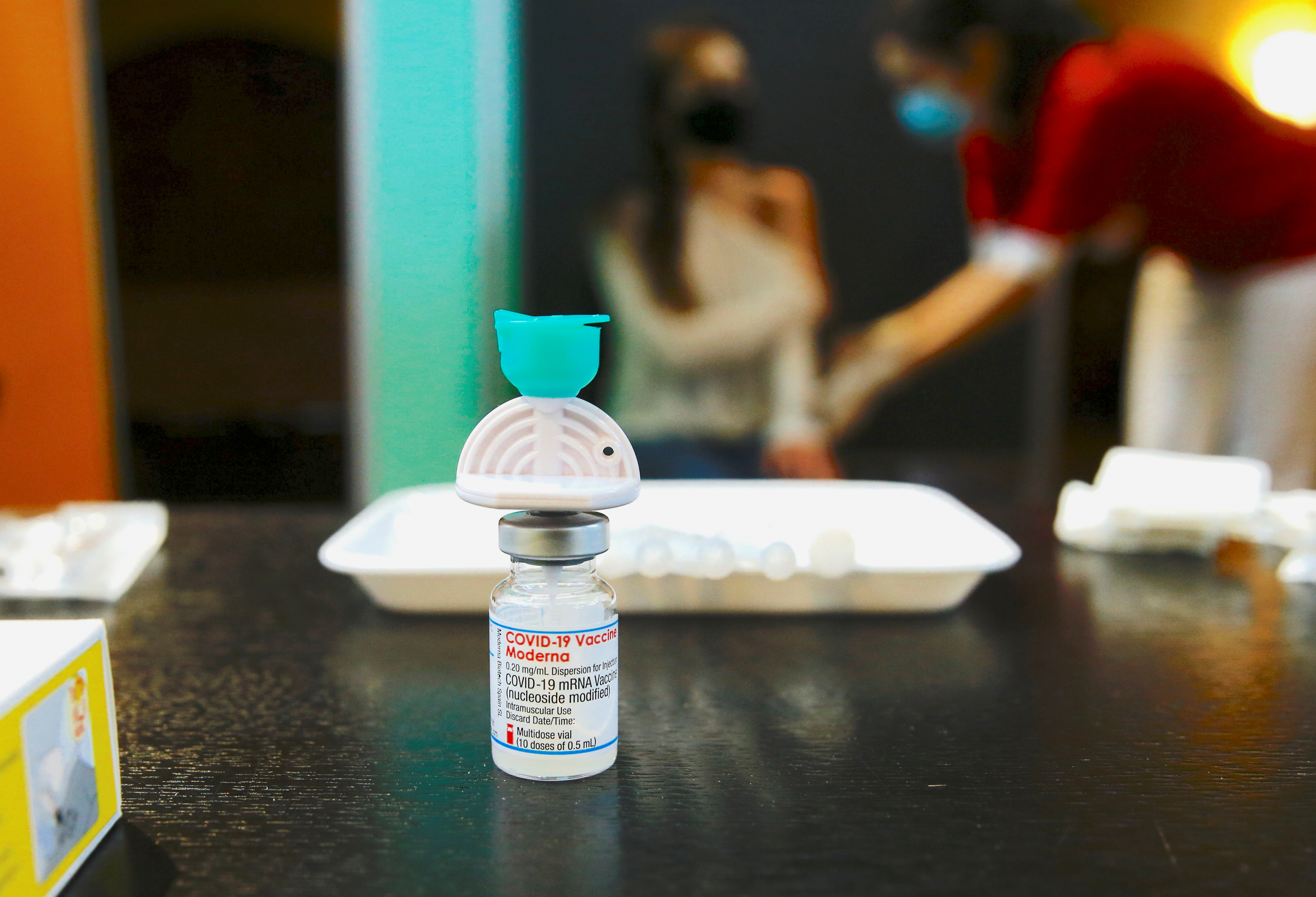 A vial containing the Moderna COVID-19 vaccine is seen at a temporary vaccination center in the Offene St. Jakob Kirche church in Zurich