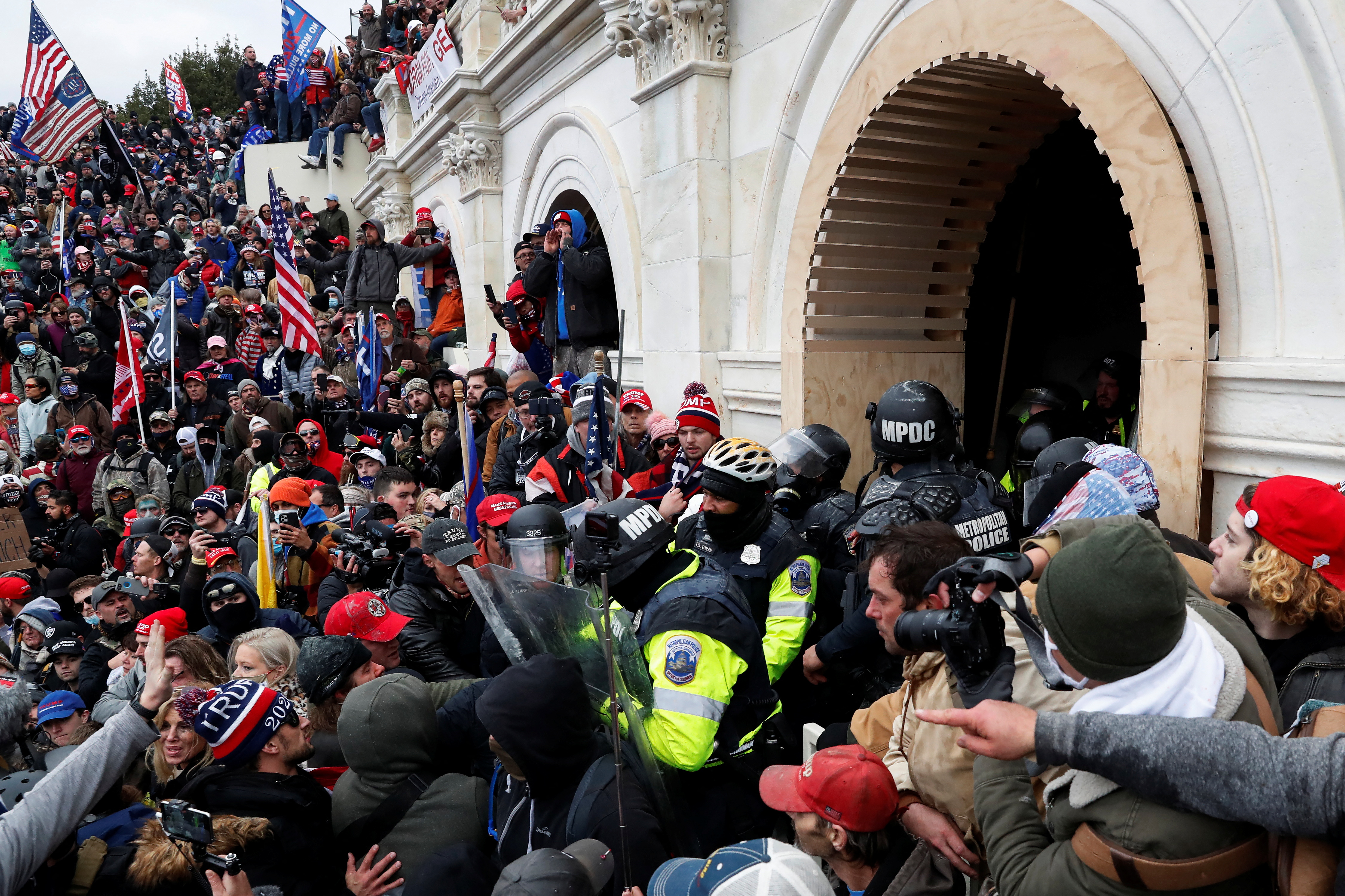 Pro-Trump protesters clash with police during a rally to contest the certification of the 2020 U.S. presidential election results by the U.S. Congress, at the U.S. Capitol Building in Washington