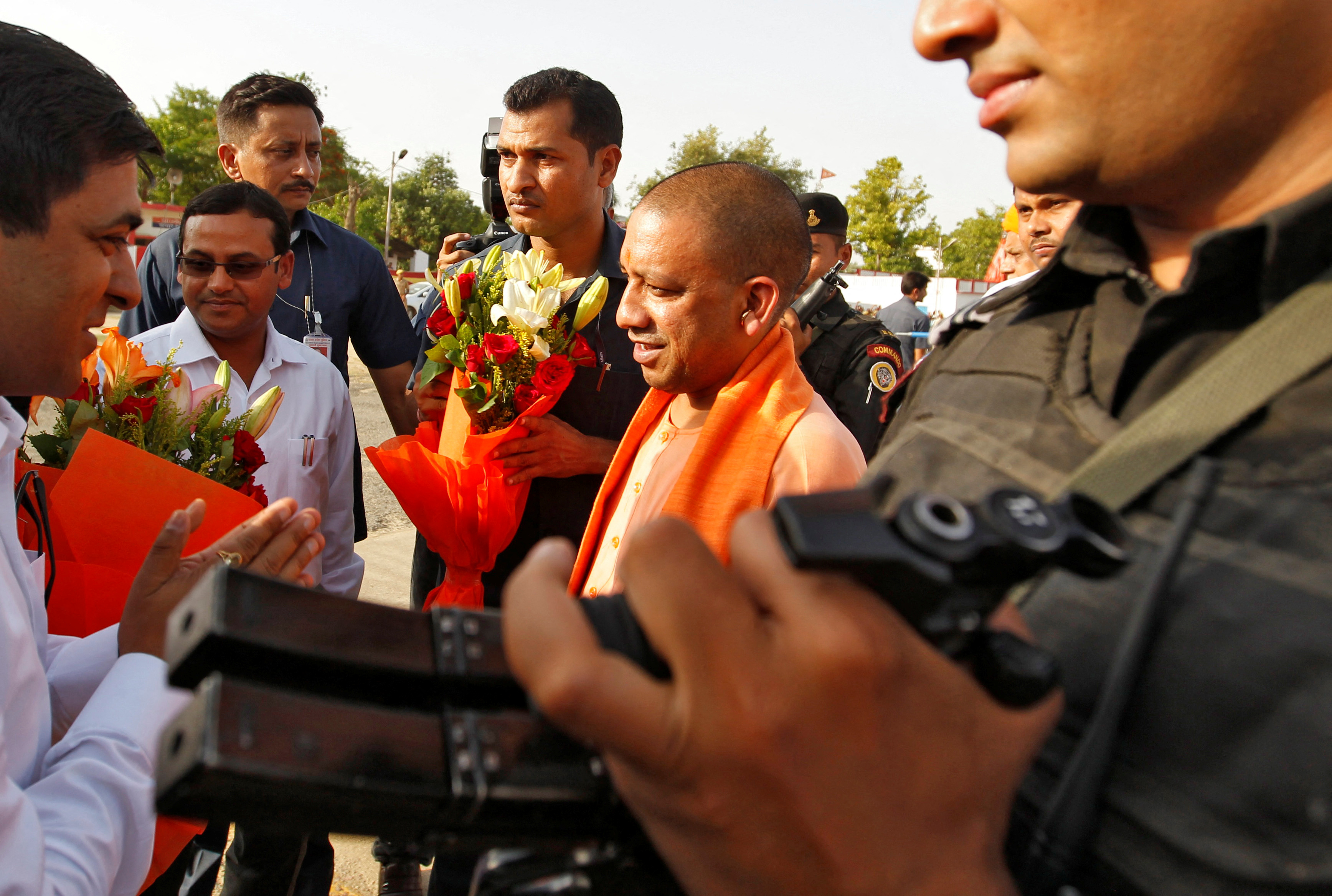 Yogi Adityanath, Chief Minister of India's most populous state of Uttar Pradesh, is welcomed by an official after he arrived for a two-day long visit to Allahabad