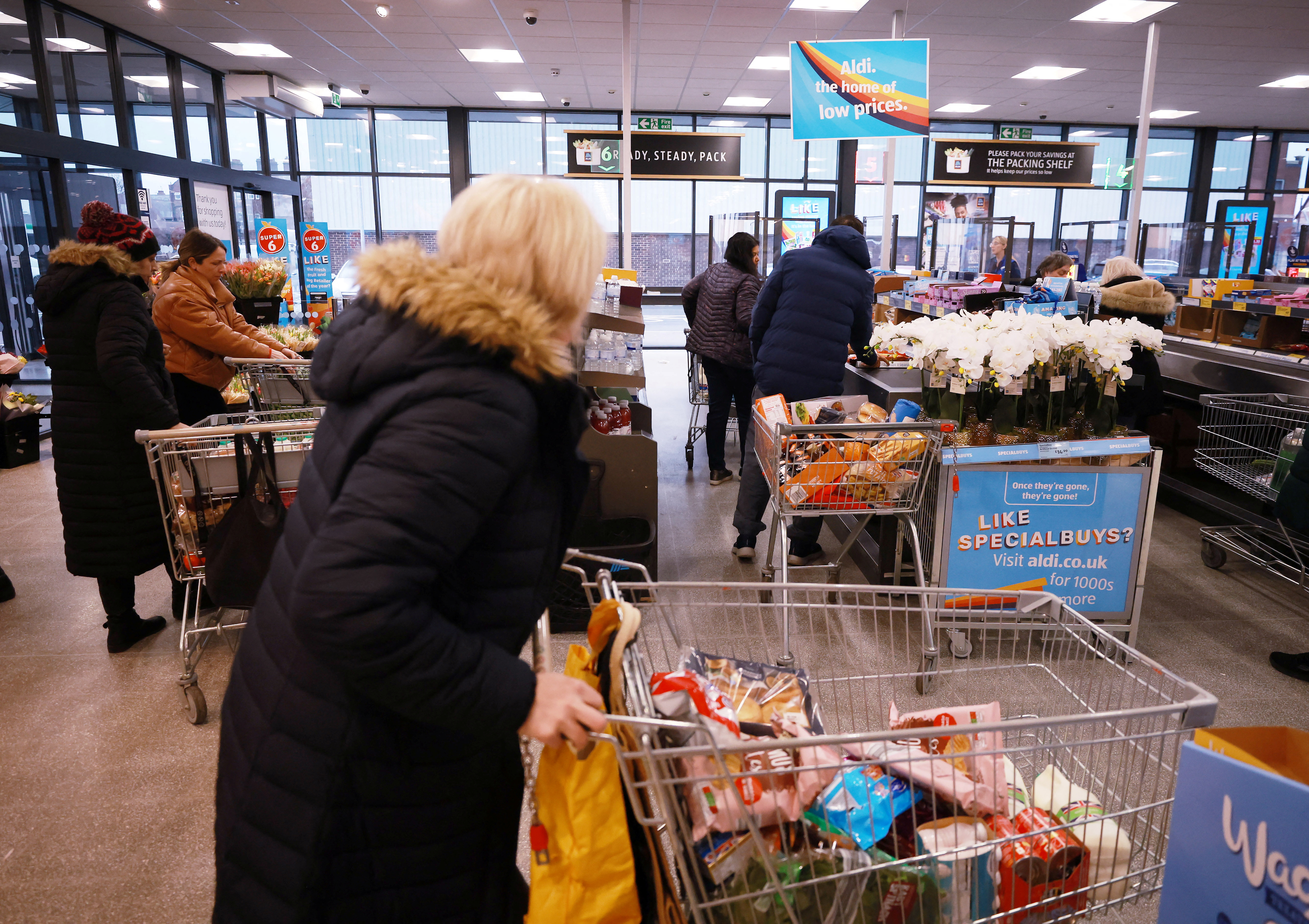People shop inside an ALDI supermarket near Altrincham