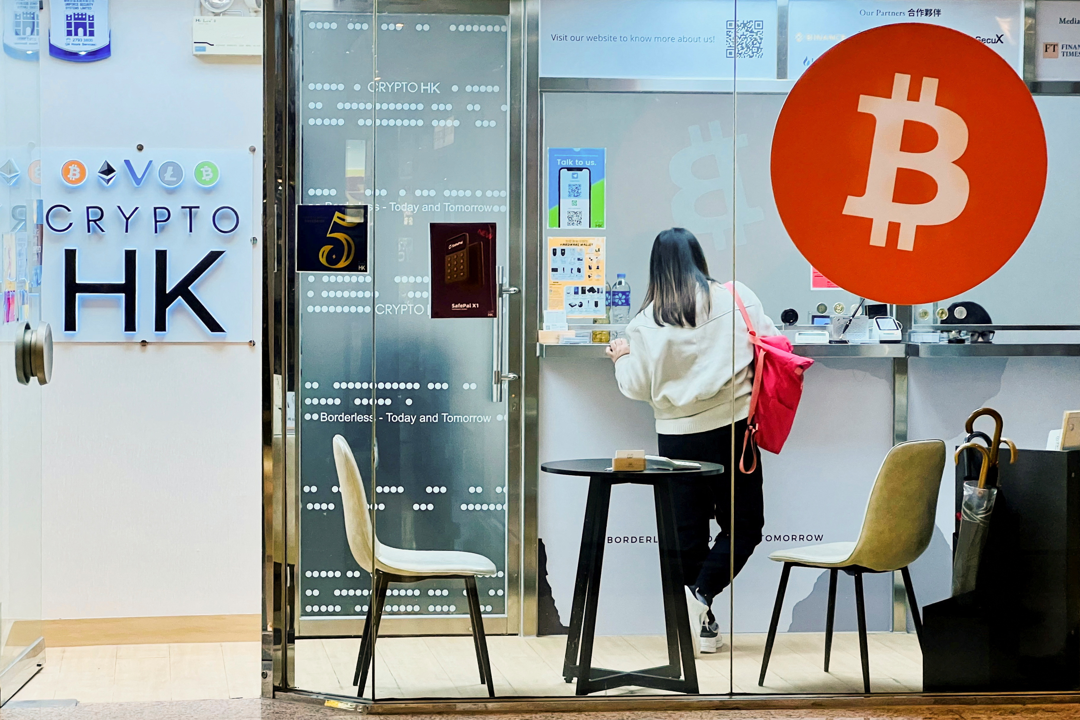 A woman stands at the counter of a Crypto HK office in Hong Kong