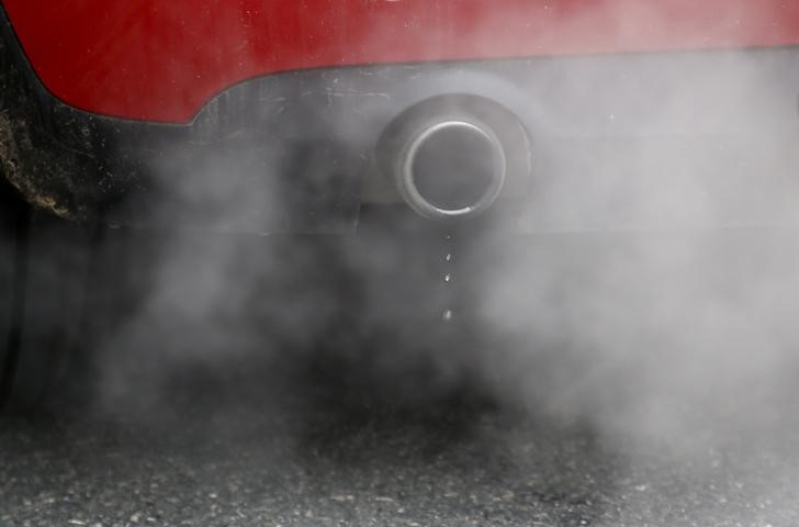 An exhaust emits fumes as a car is driven through Richmond in London