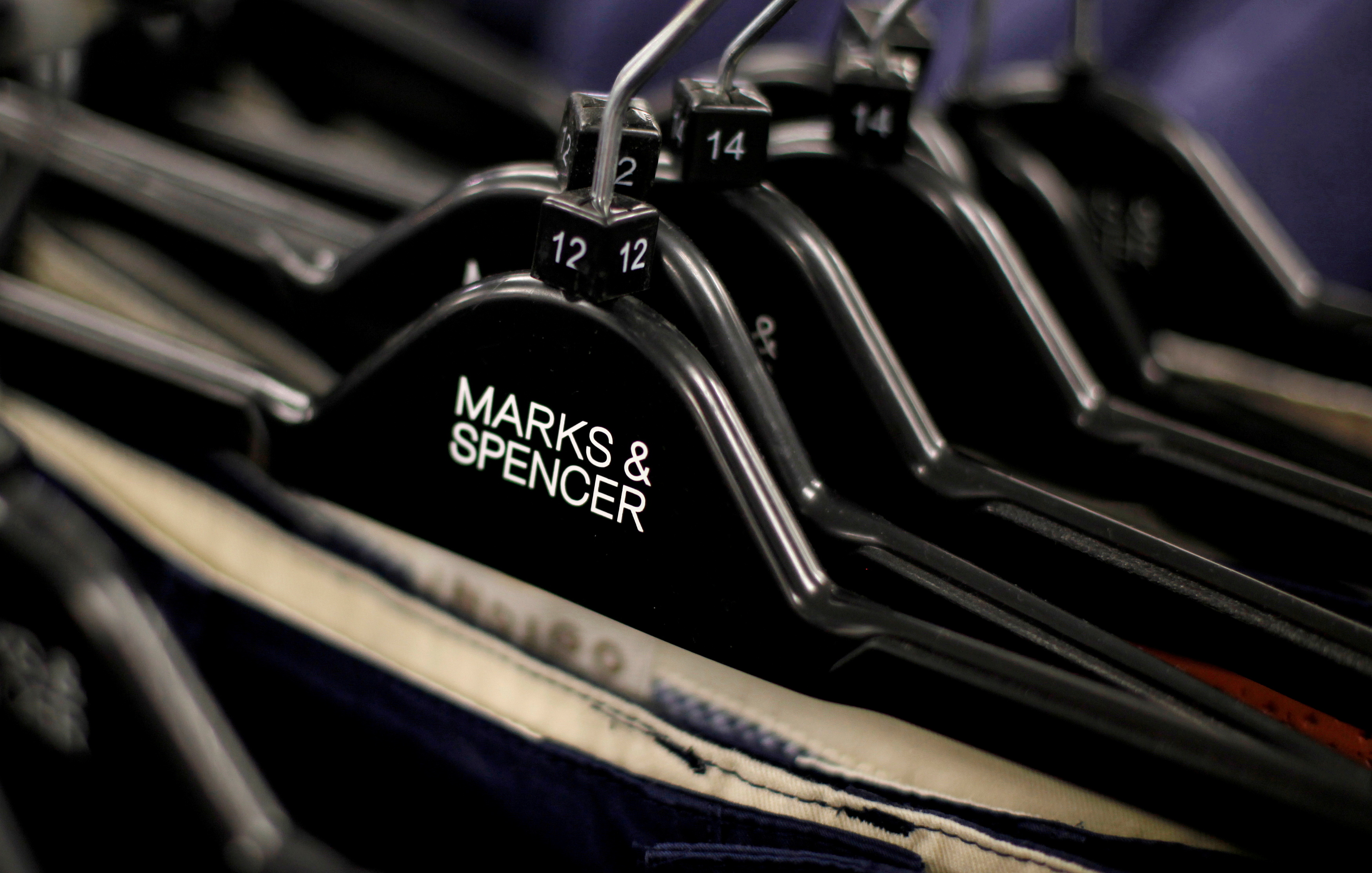 Clothes displayed on hangers in an Marks & Spencer shop in northwest London