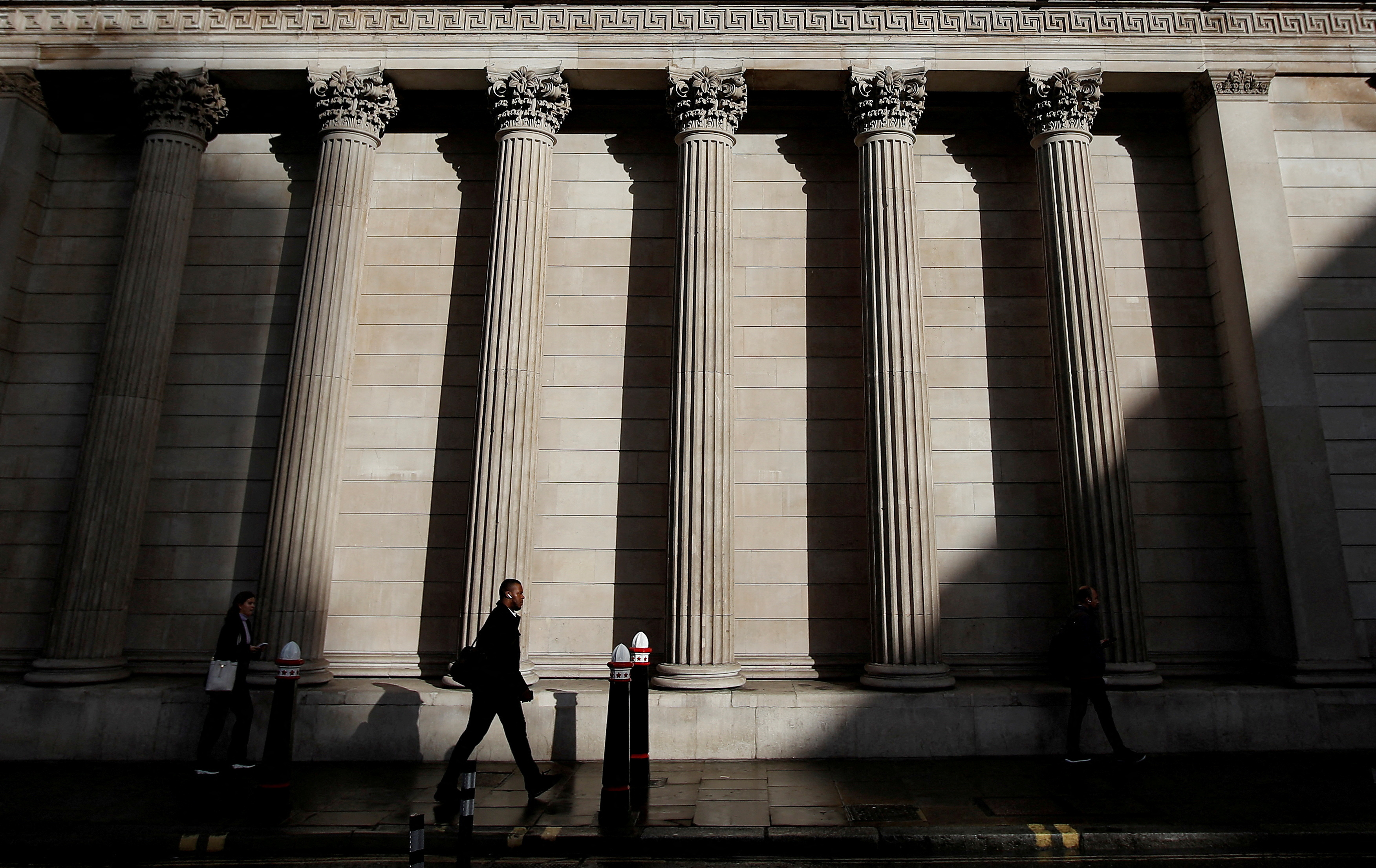 A commuter walks past the Bank of England in London