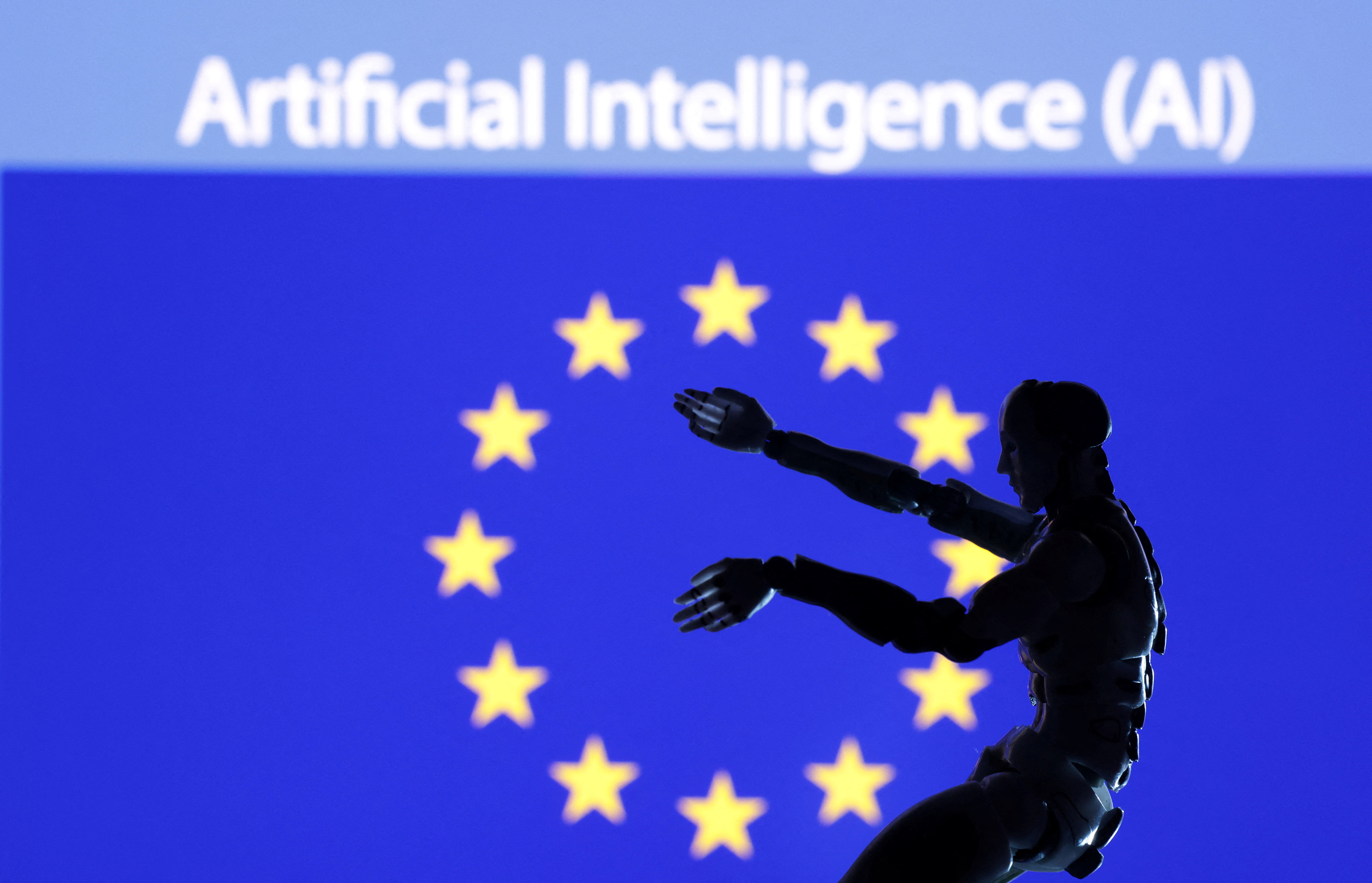 Illustration shows AI Artificial intelligence words, miniature of robot and EU flag