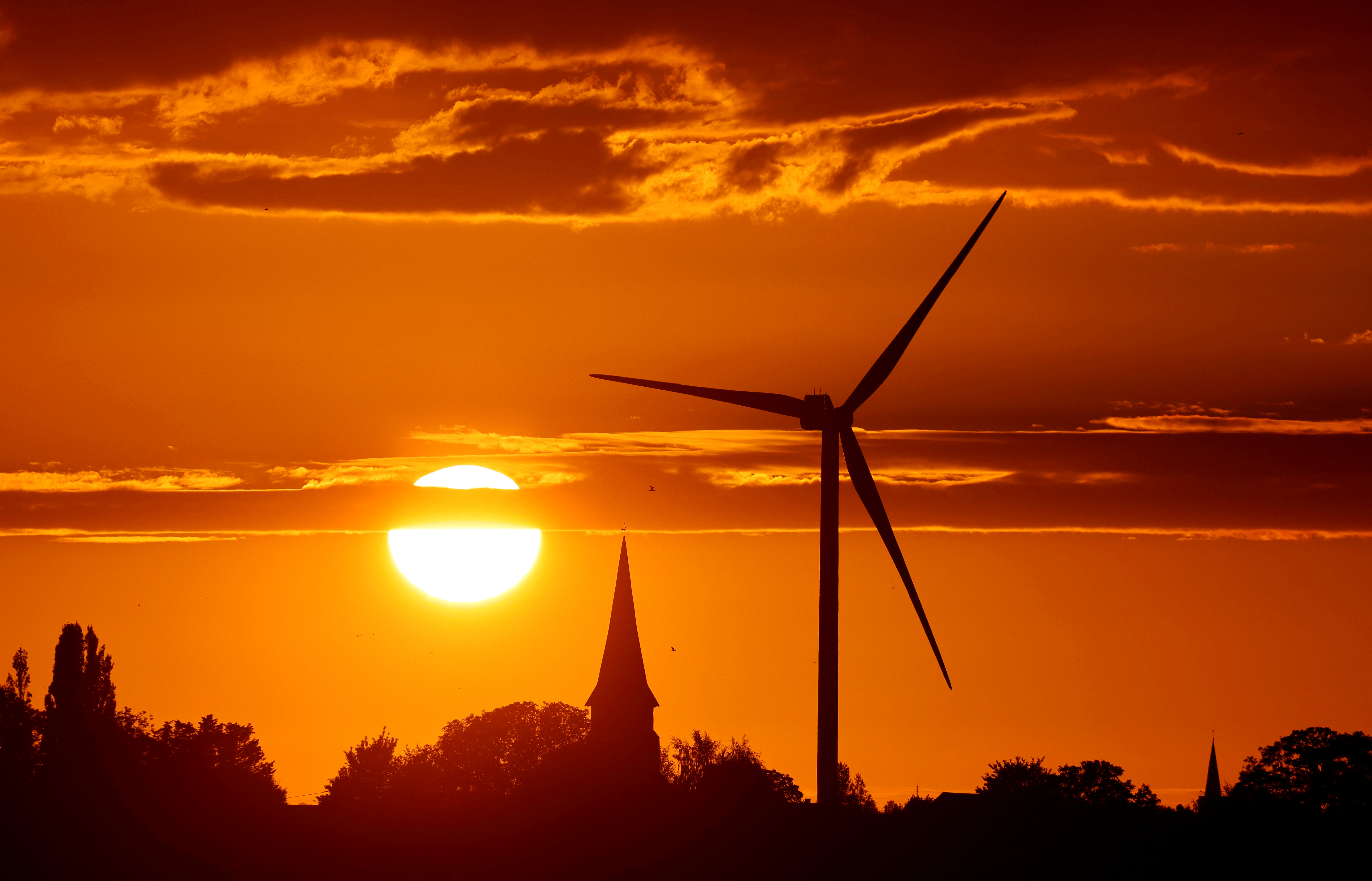A power-generating windmill turbine is pictured during sunset at a renewable energy park in Ecoust-Saint-Mein, France