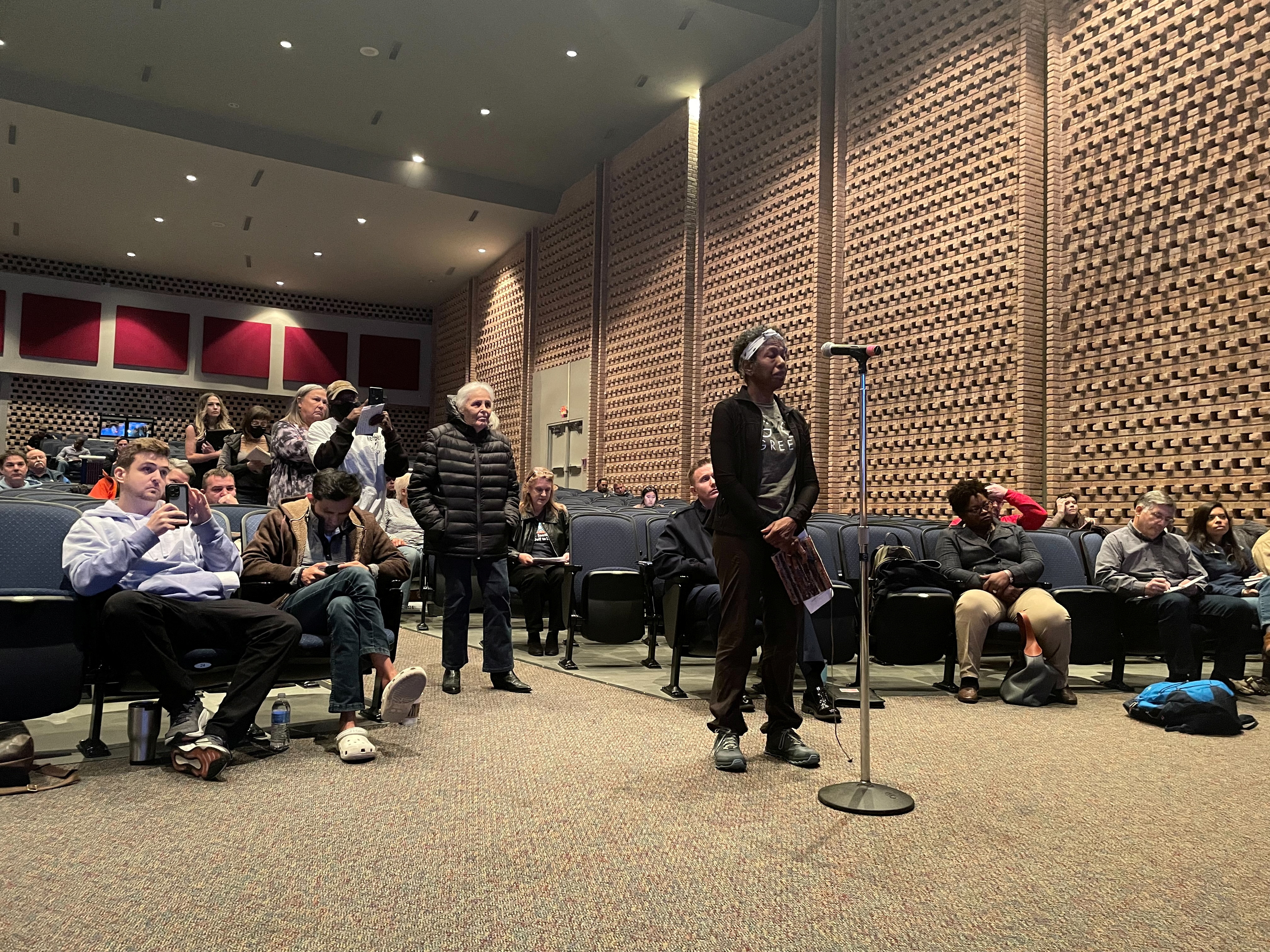 Residents line up to question U.S. energy and safety regulators during a meeting to review plans to restart the Freeport LNG gas-export facility idled by fire last year in Freeport, Texas