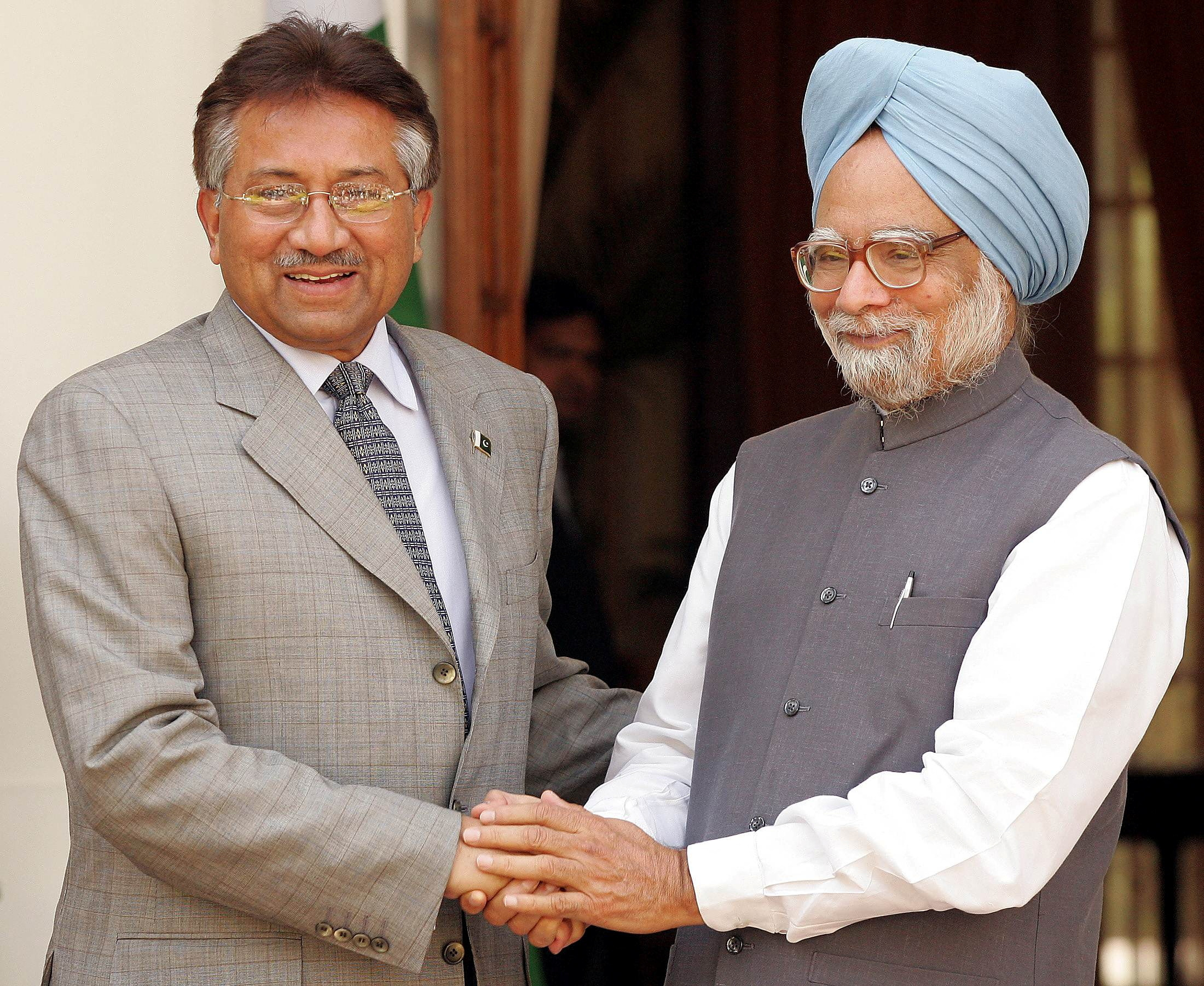 Pakistan's President Musharraf shakes hands with Indian Prime Minister Singh in New Delhi.