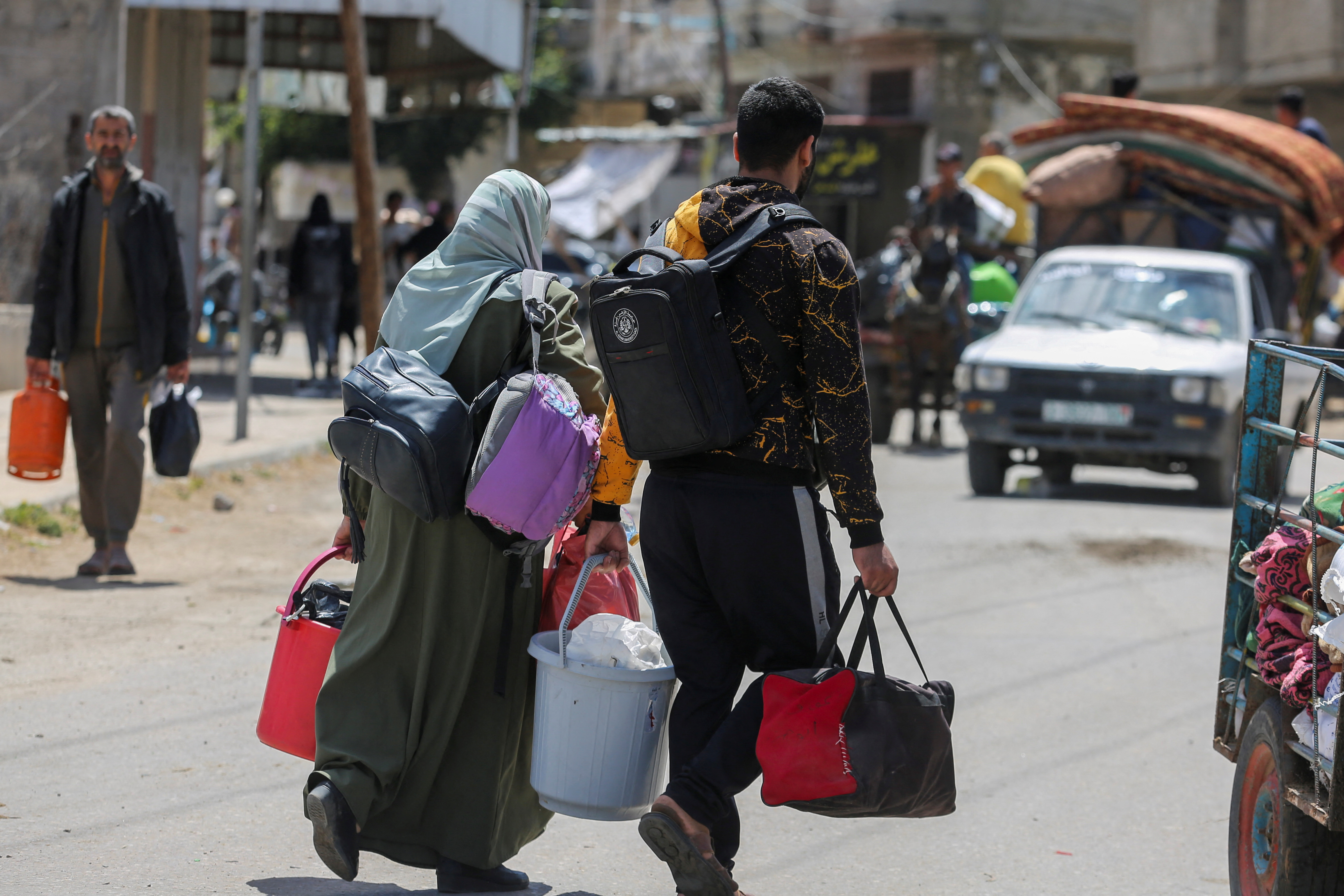 People flee the eastern parts of Rafah after the Israeli military began evacuating Palestinian civilians ahead of a threatened assault on the southern Gazan city