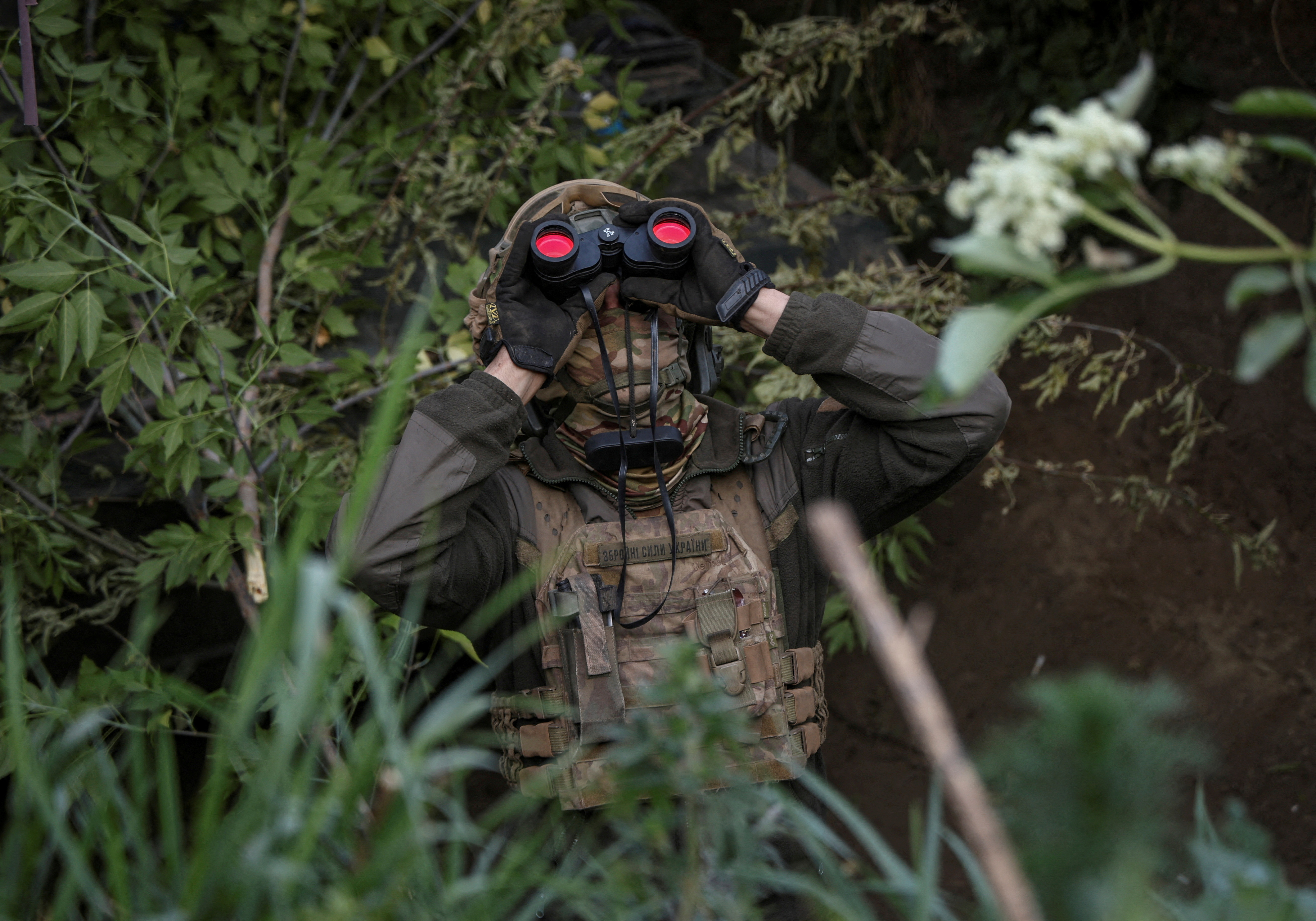 A Ukrainian serviceman from an air defence unit monitors the sky at a frontline near the town of Bakhmut