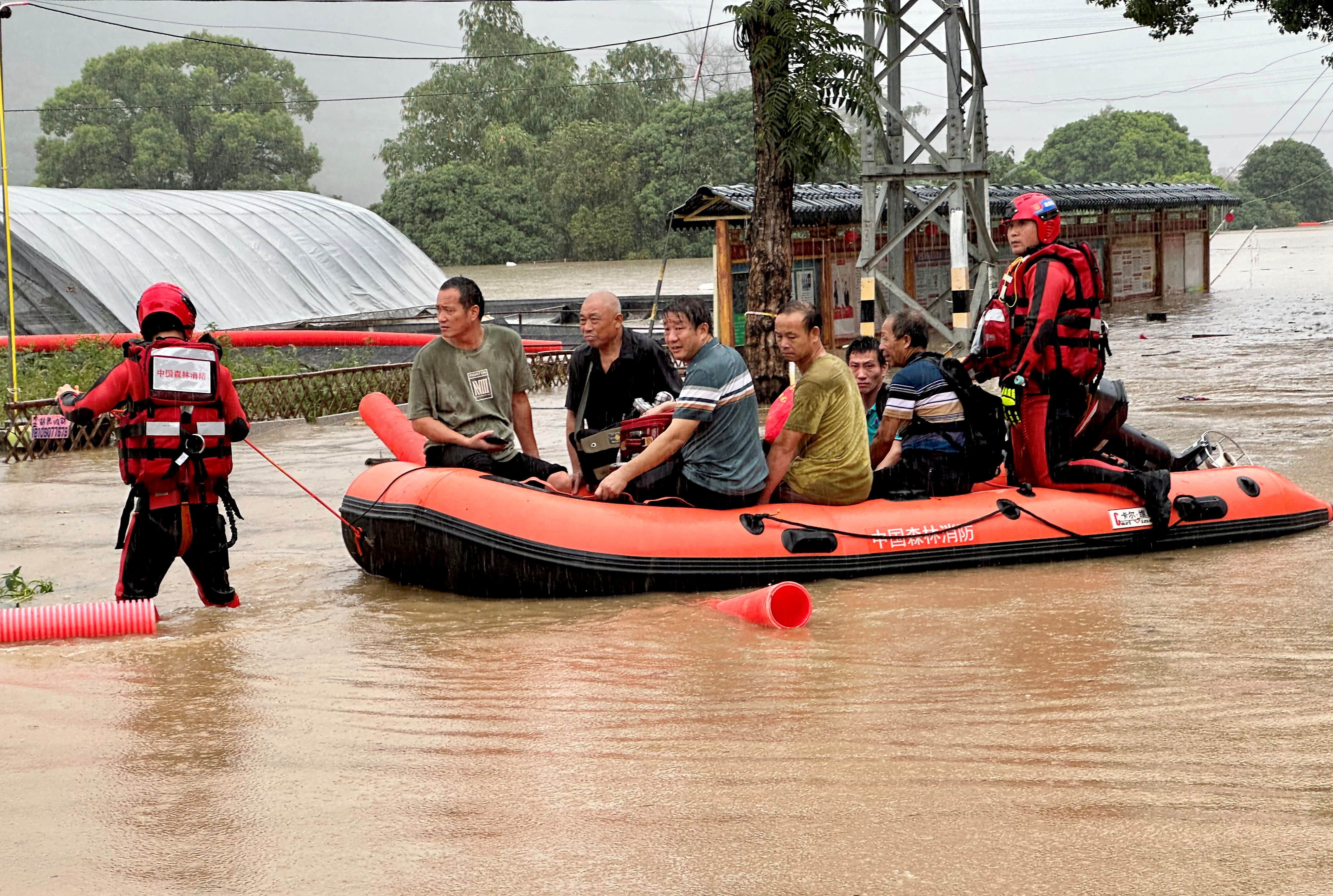 Rescue workers evacuate residents in Minhou county after heavy rains brought by typhoon Haikui