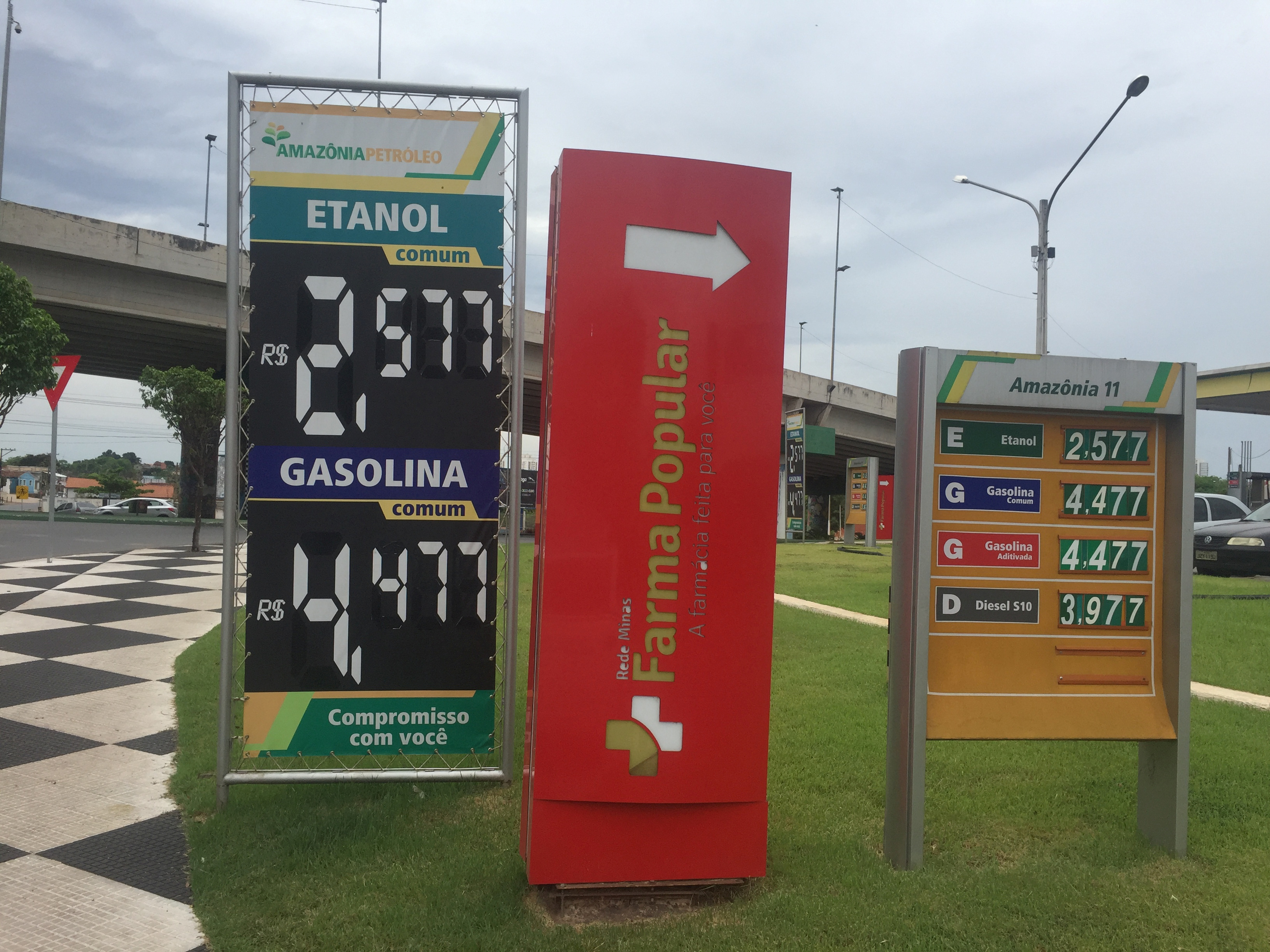A placard shows prices for ethanol and gasoline at a gas station in Cuiaba
