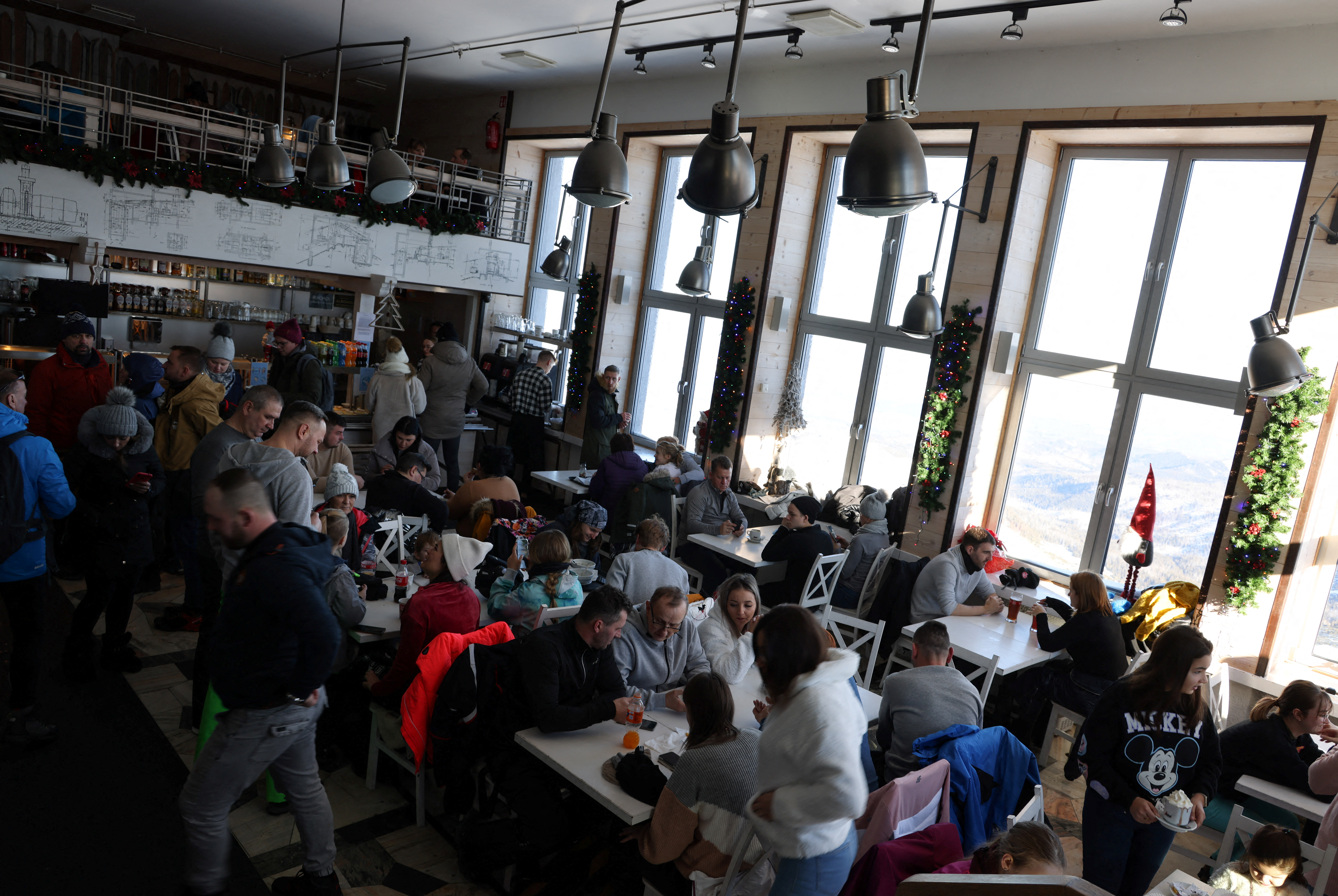 People sit in a restaurant on top of the Kasprowy Wierch mountain, in Zakopane