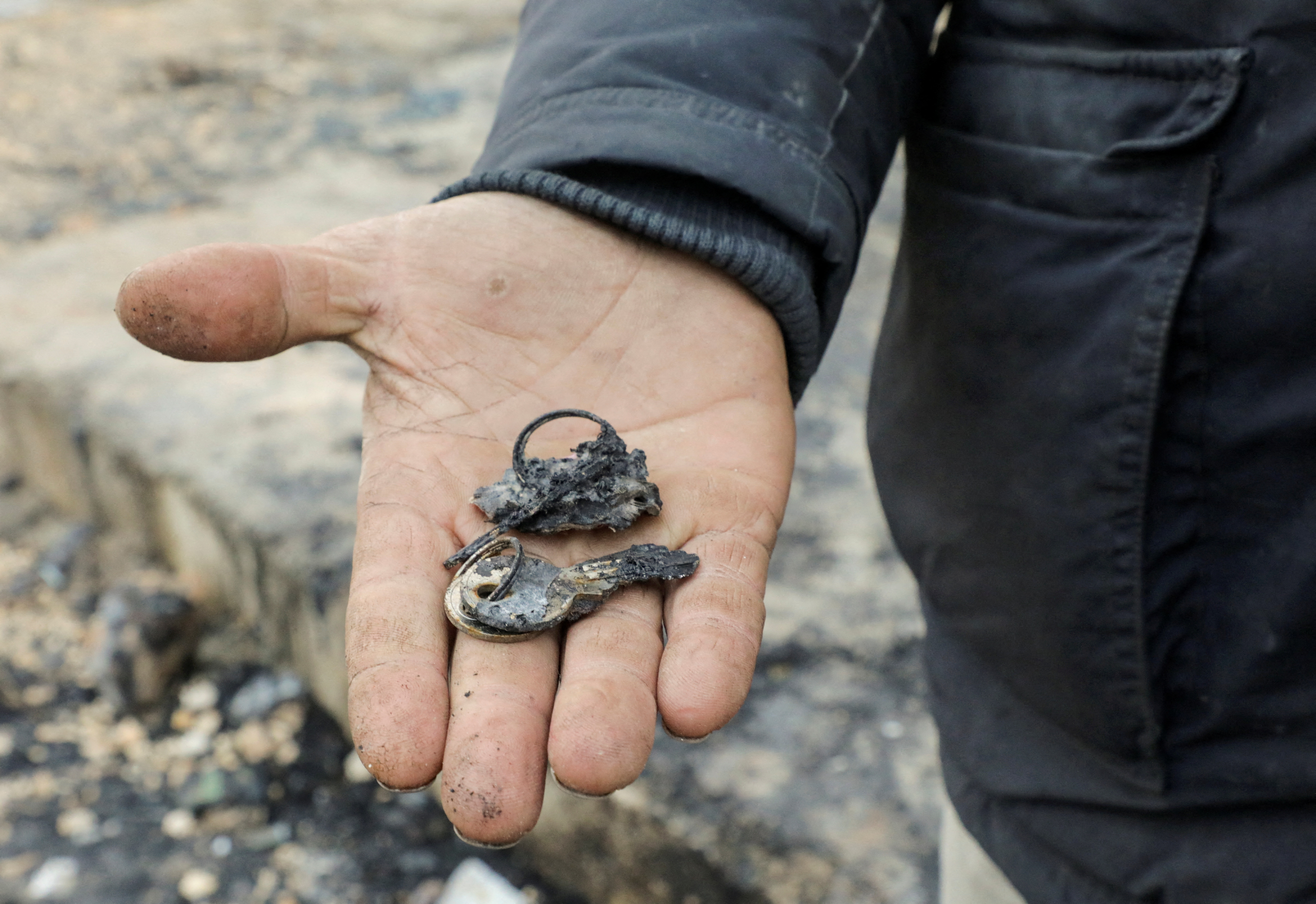 Nouredin al-Abdullah, a cousin of Ahmed al-Abdullah, who is the father of the girls Lin and Intissar and died as a heater ignited their tent, holds burnt keys of the destroyed tent at a camp for the internally displaced in Aleppo countryside