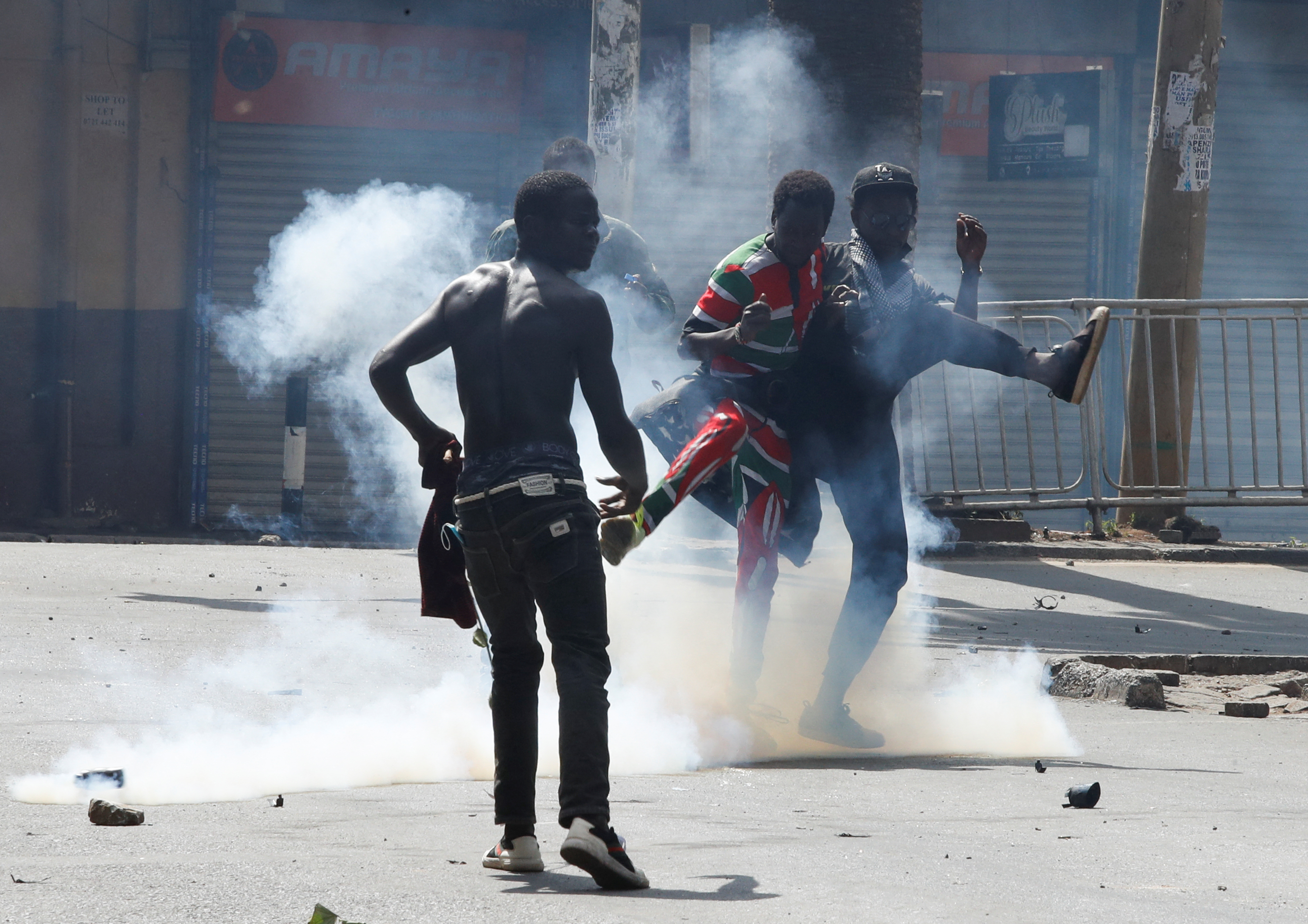 Demonstrators react as police use tear gas to disperse protesters during a demonstration against Kenya's proposed finance bill 2024/2025 in Nairobi, Kenya, June 25, 2024. REUTERS/Monicah Mwangi 