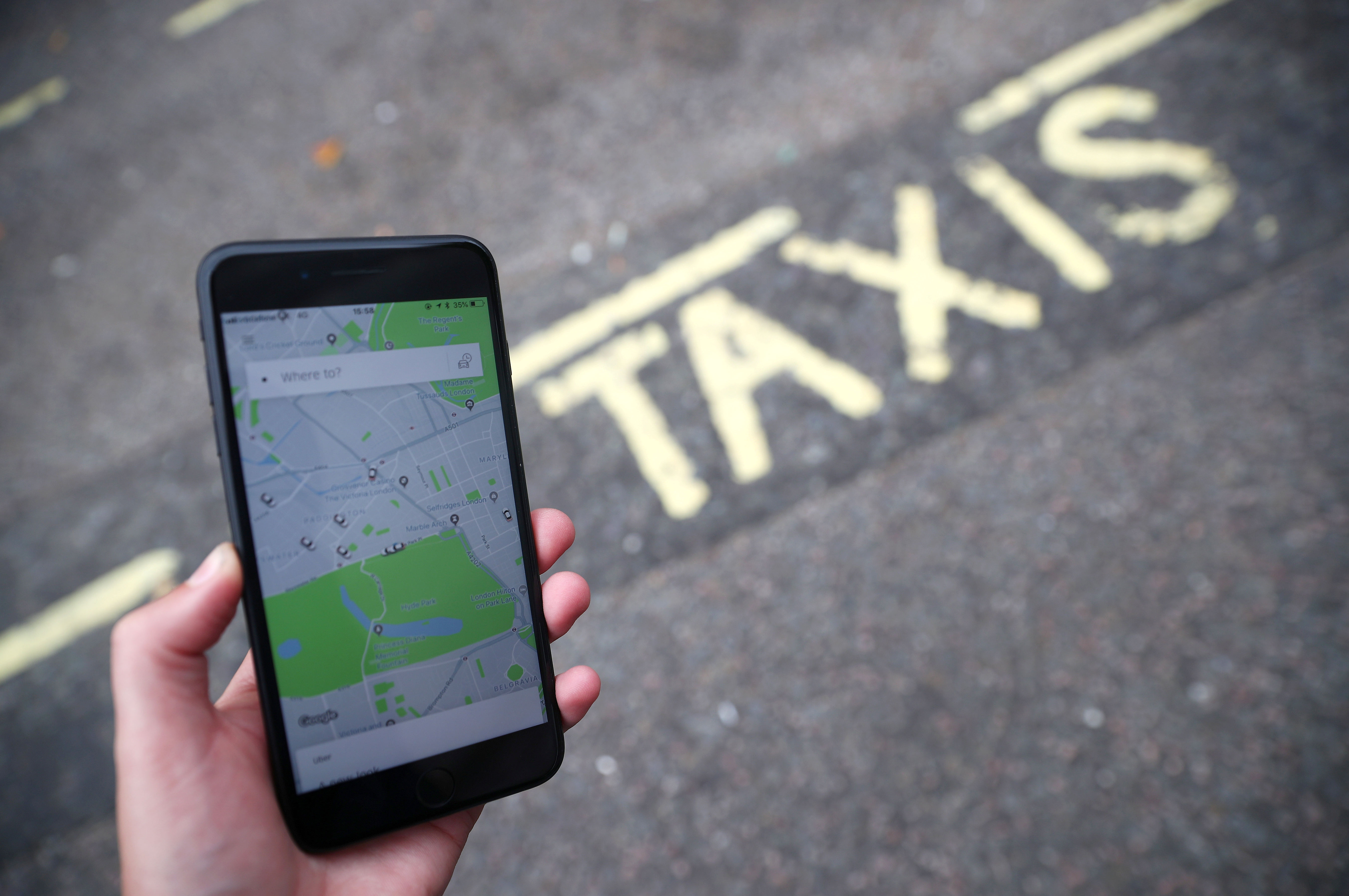 The Uber application is seen on a mobile phone in London