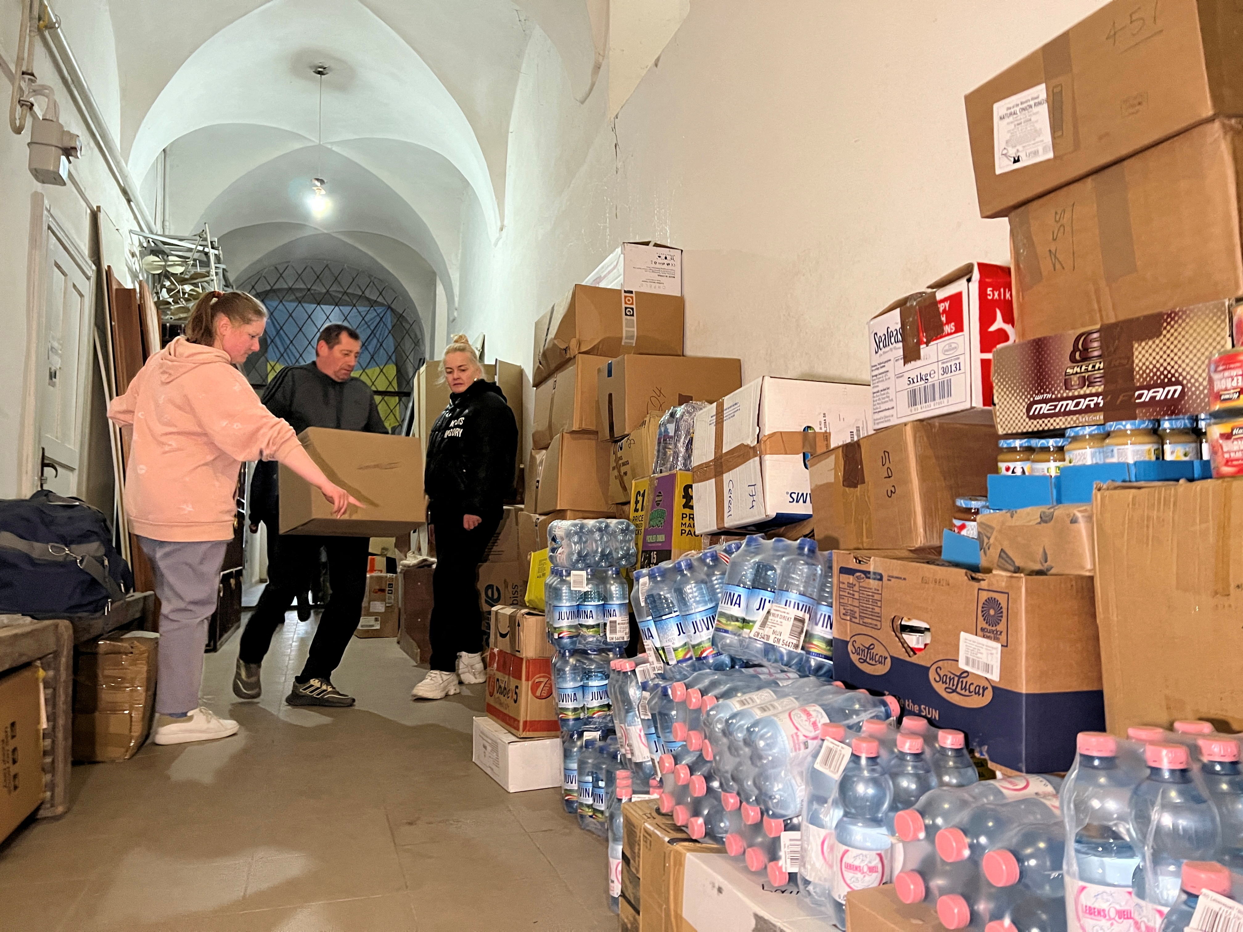 Ukrainian refugee Luidmyla Nazarova and other volunteers deliver humanitarian aid to St. George's Cathedral, in Lviv