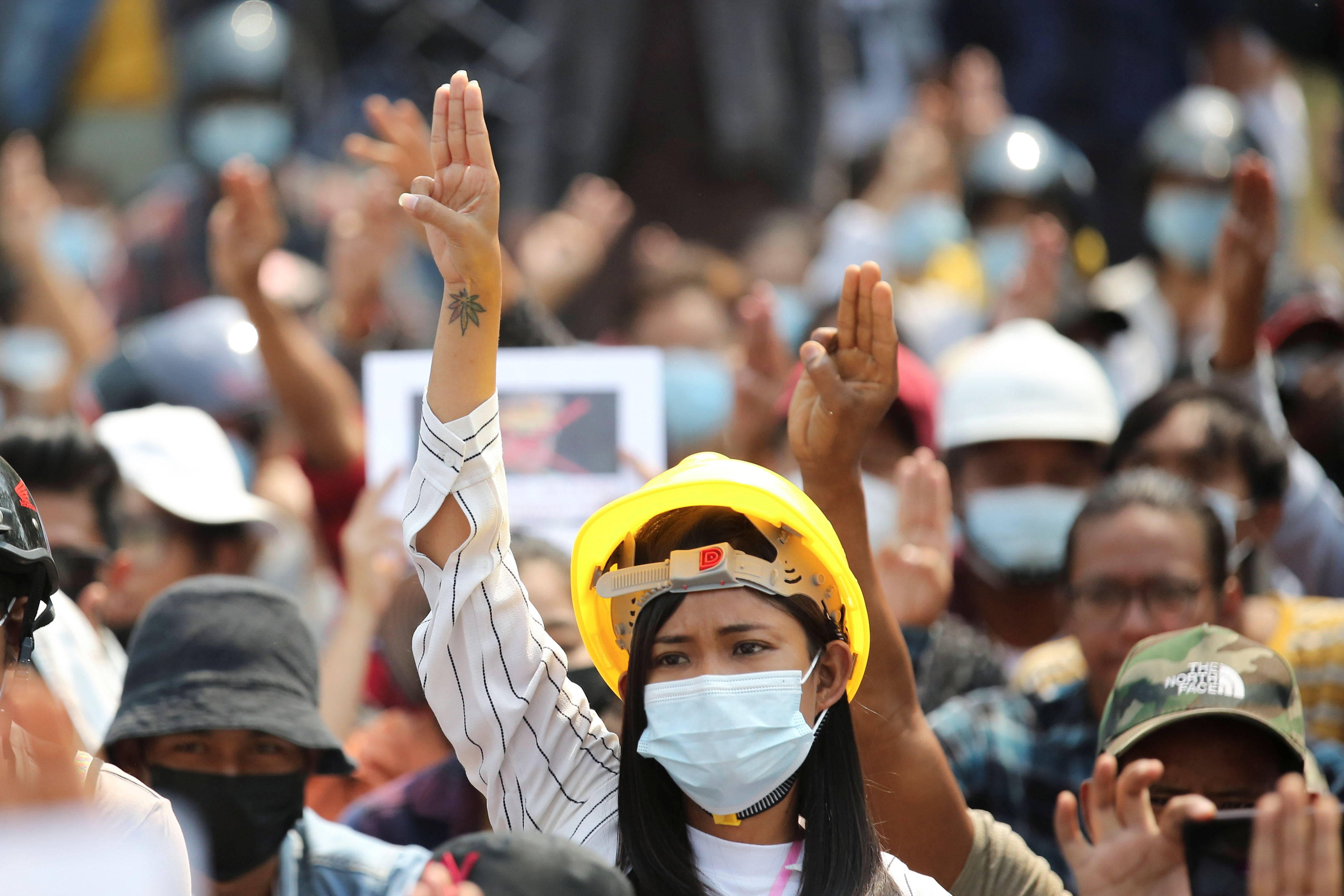 A woman shows a three-finger salute during a protest against the military coup in Naypyitaw, Myanmar, March 8, 2021. REUTERS/Stringer