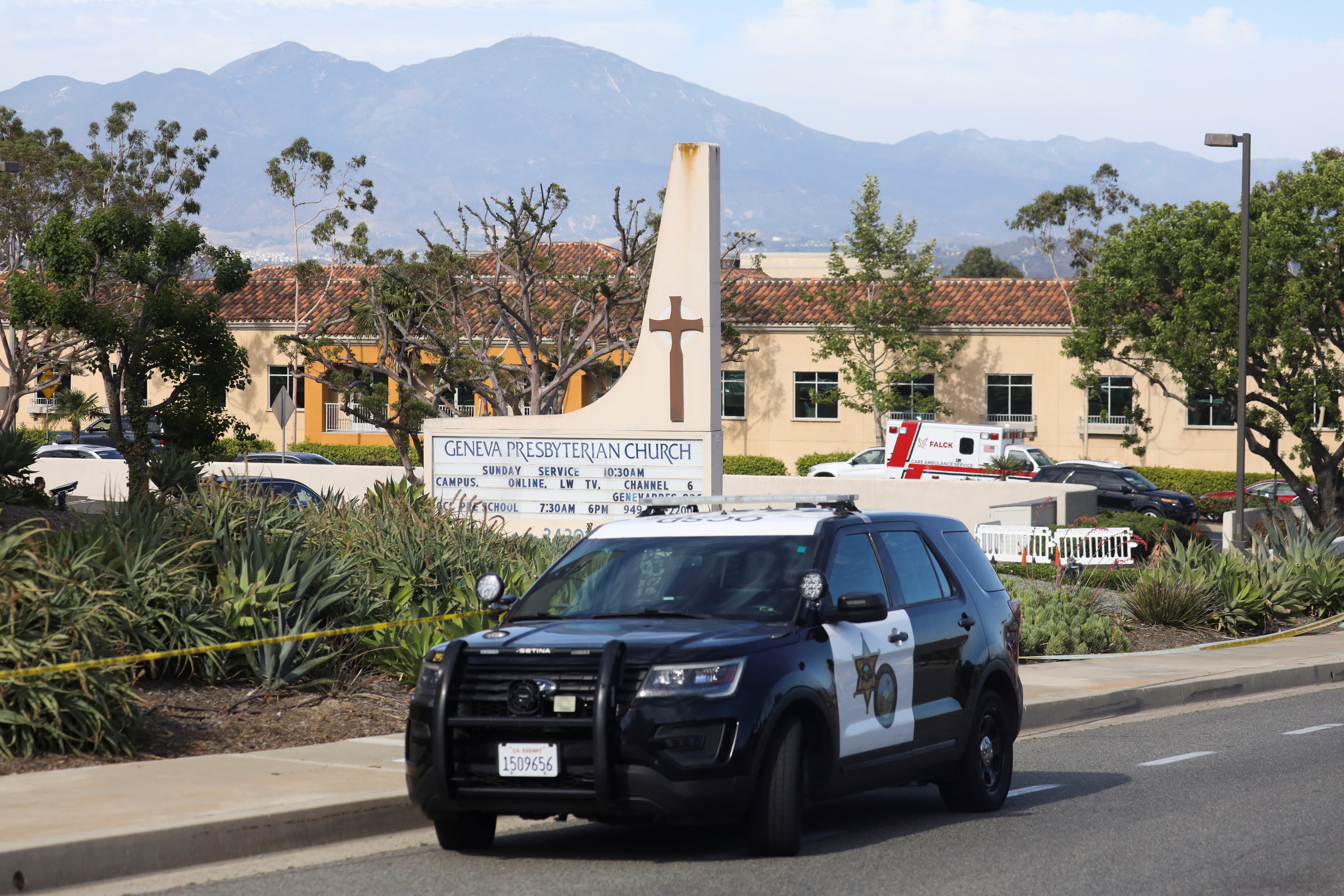A police car is seen after a deadly shooting at Geneva Presbyterian Church in Laguna Woods