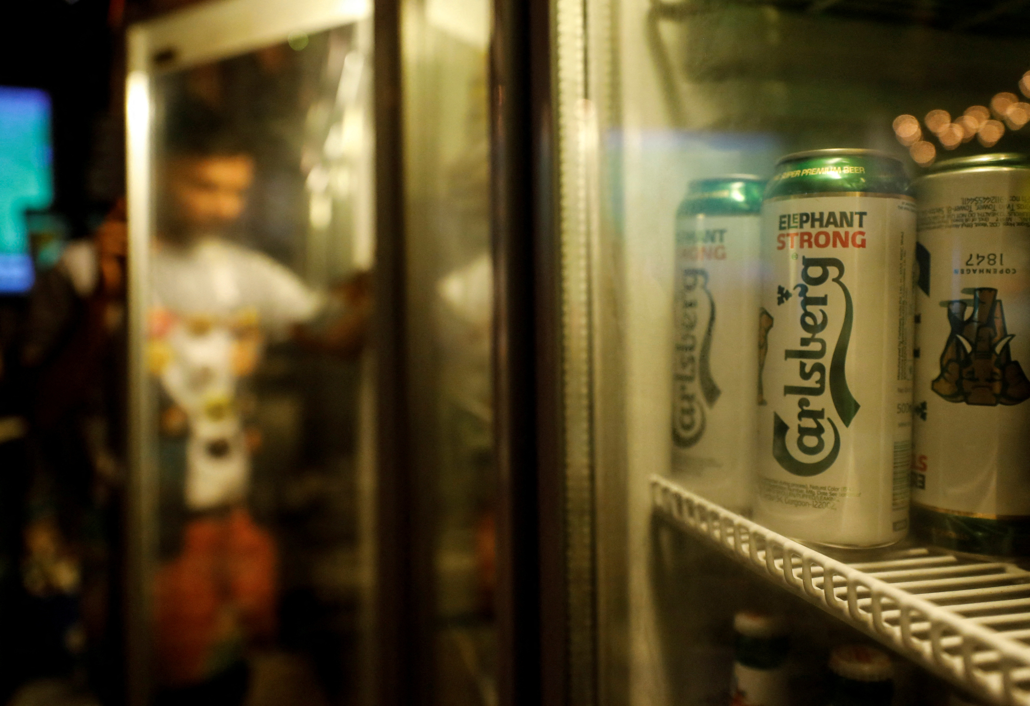 Carlsberg beer cans are seen at a pub in Mumbai