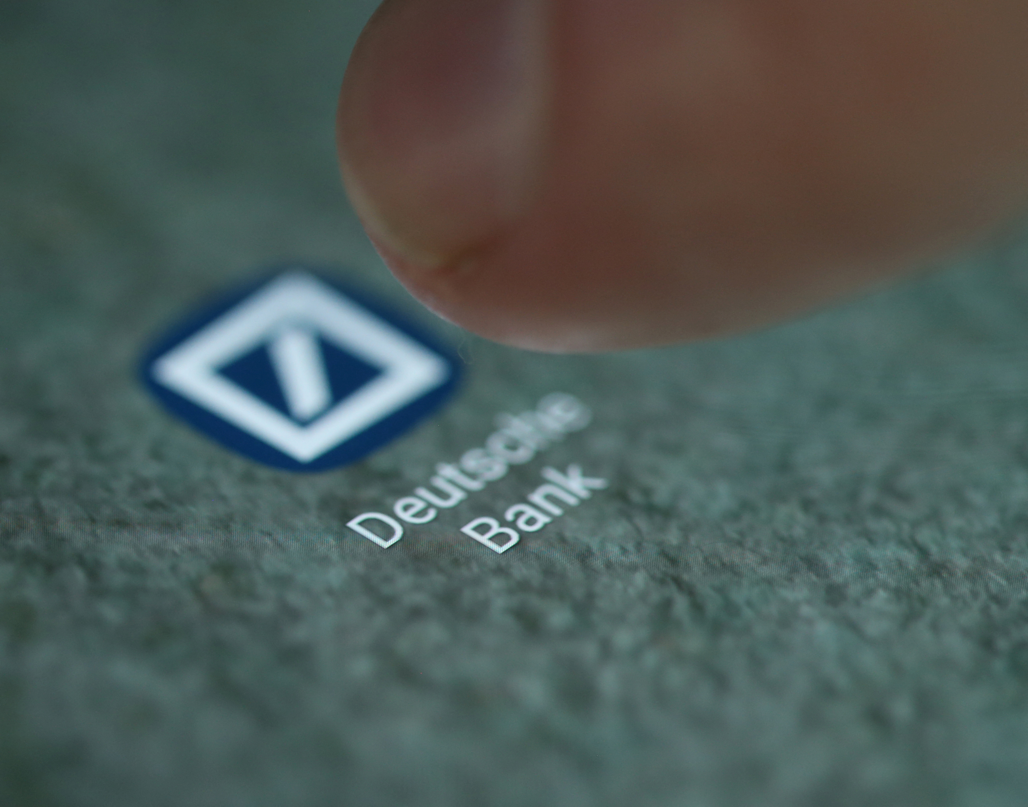 The Deutsche Bank app logo is seen on a smartphone in this illustration