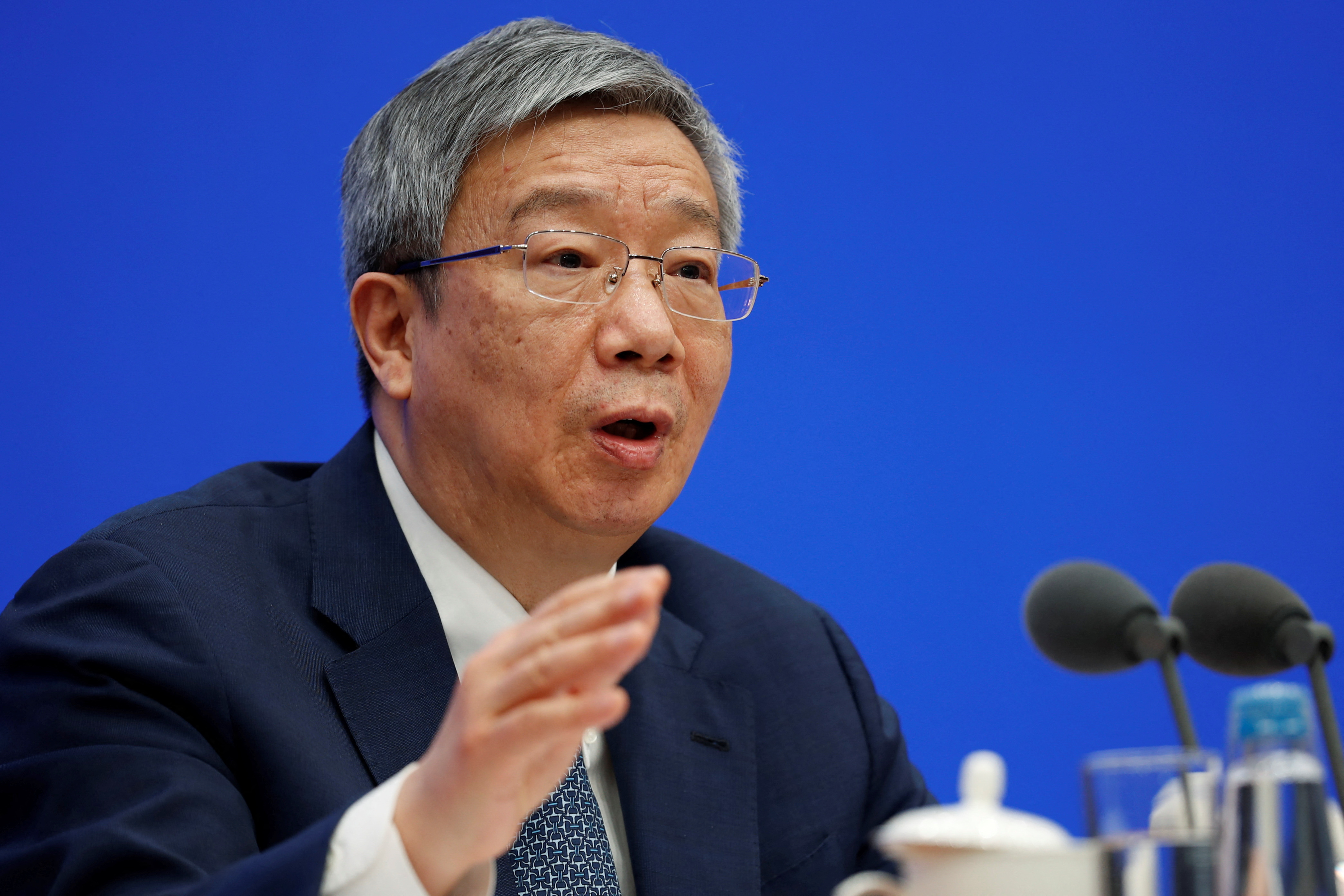 PBOC Governor Yi Gang attends a news conference in Beijing