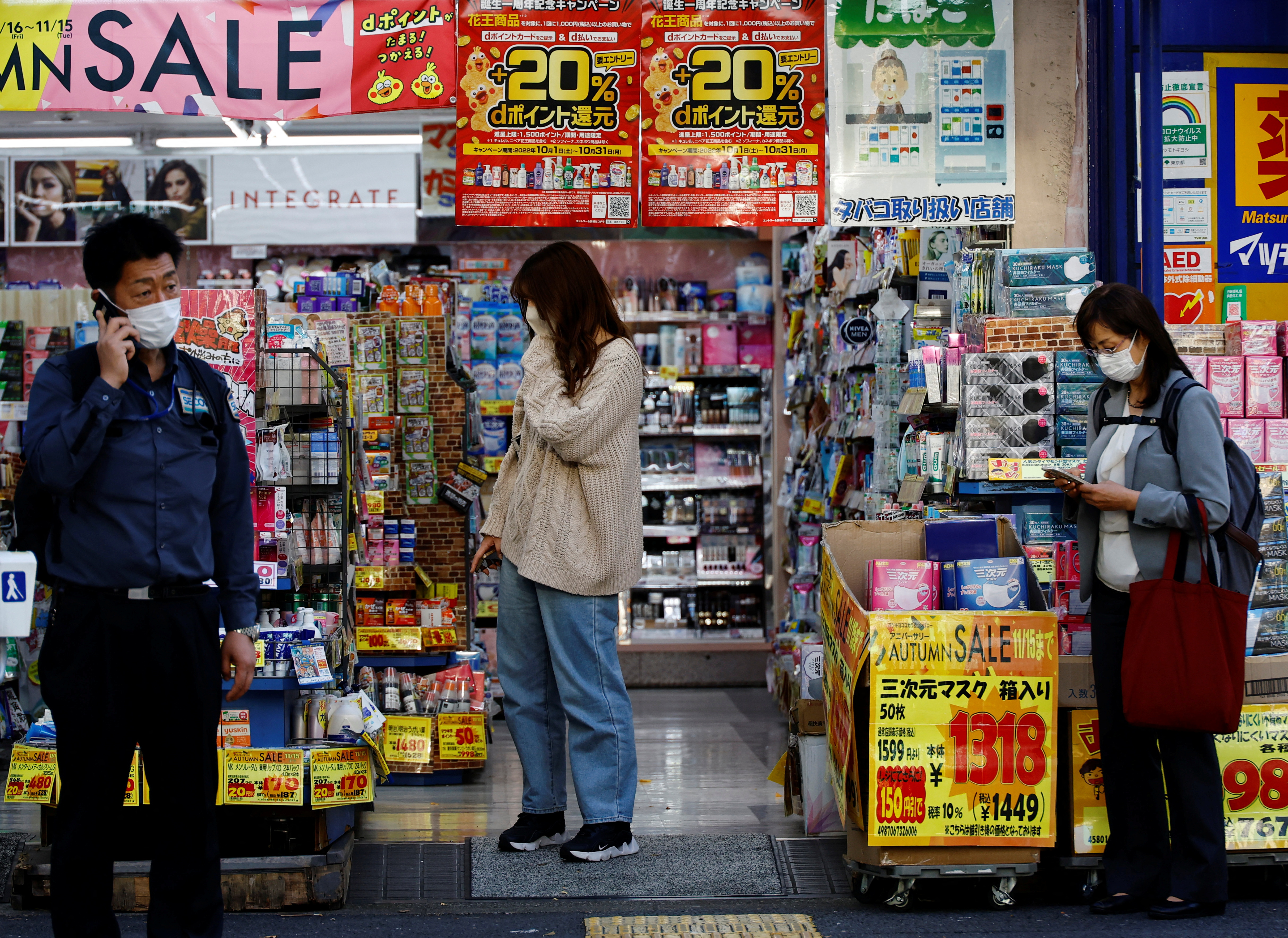 A woman chooses products at a drug store in Tokyo