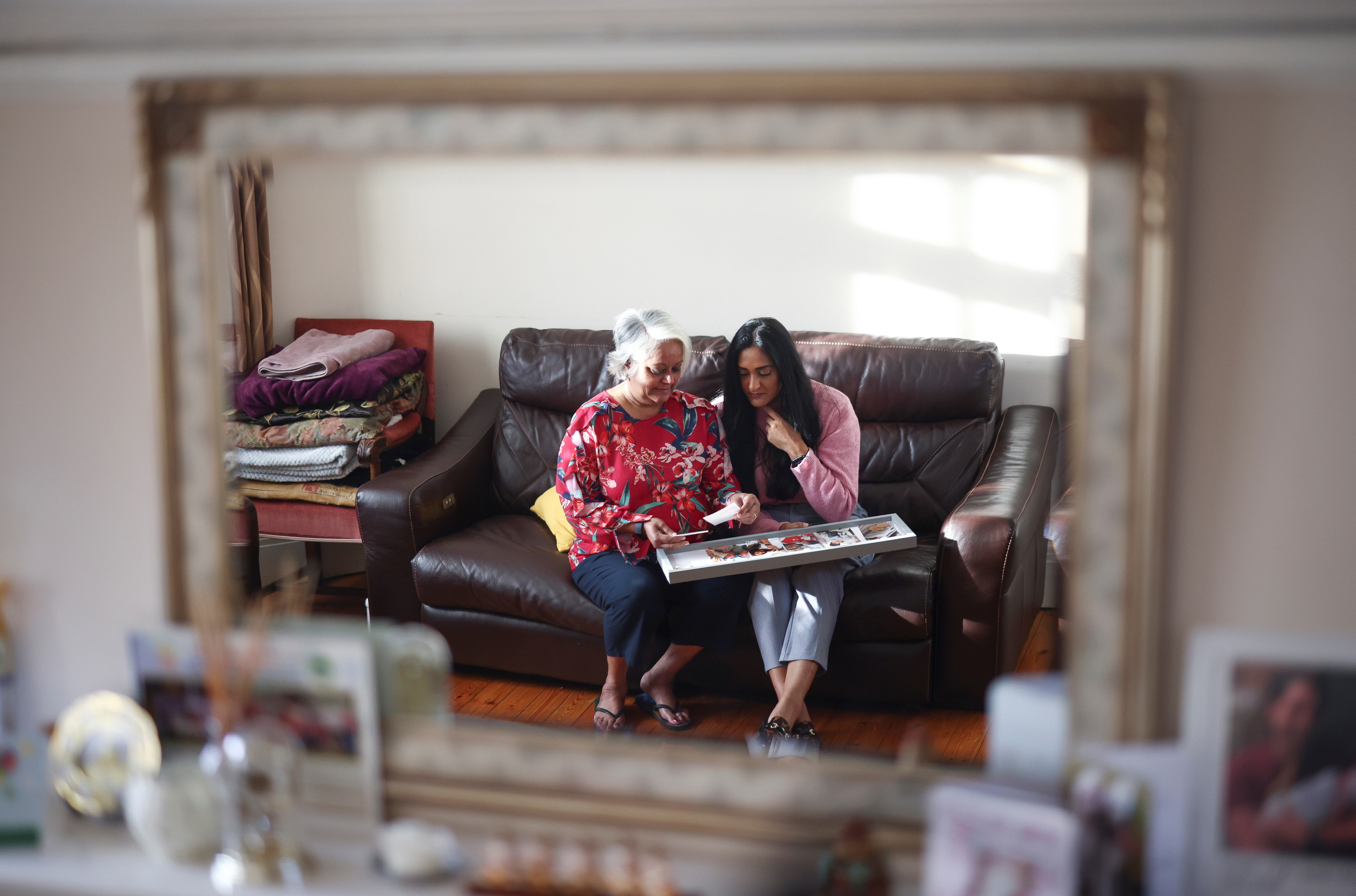 Bhavna Patel and her daughter Bindiya Patel, who are due to fly to New York to reunite with family following the relaxing of the coronavirus disease (COVID-19) travel restrictions, pose at their home in Croydon, Britain, November 5, 2021. REUTERS/Henry Nicholls