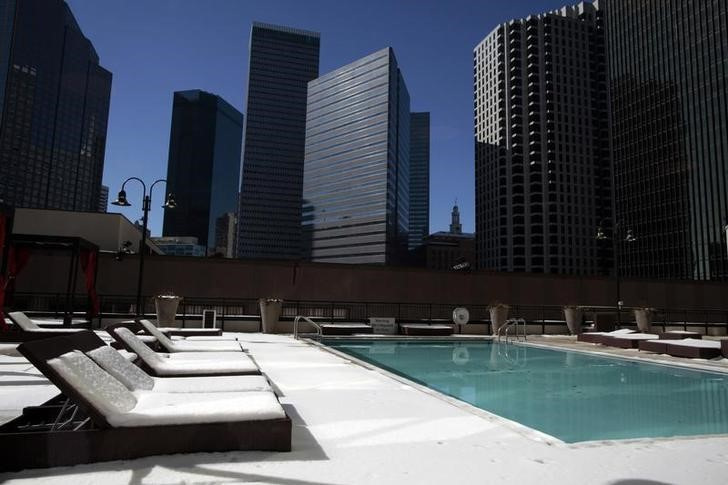 A swimming pool area is covered in snow in downtown Dallas