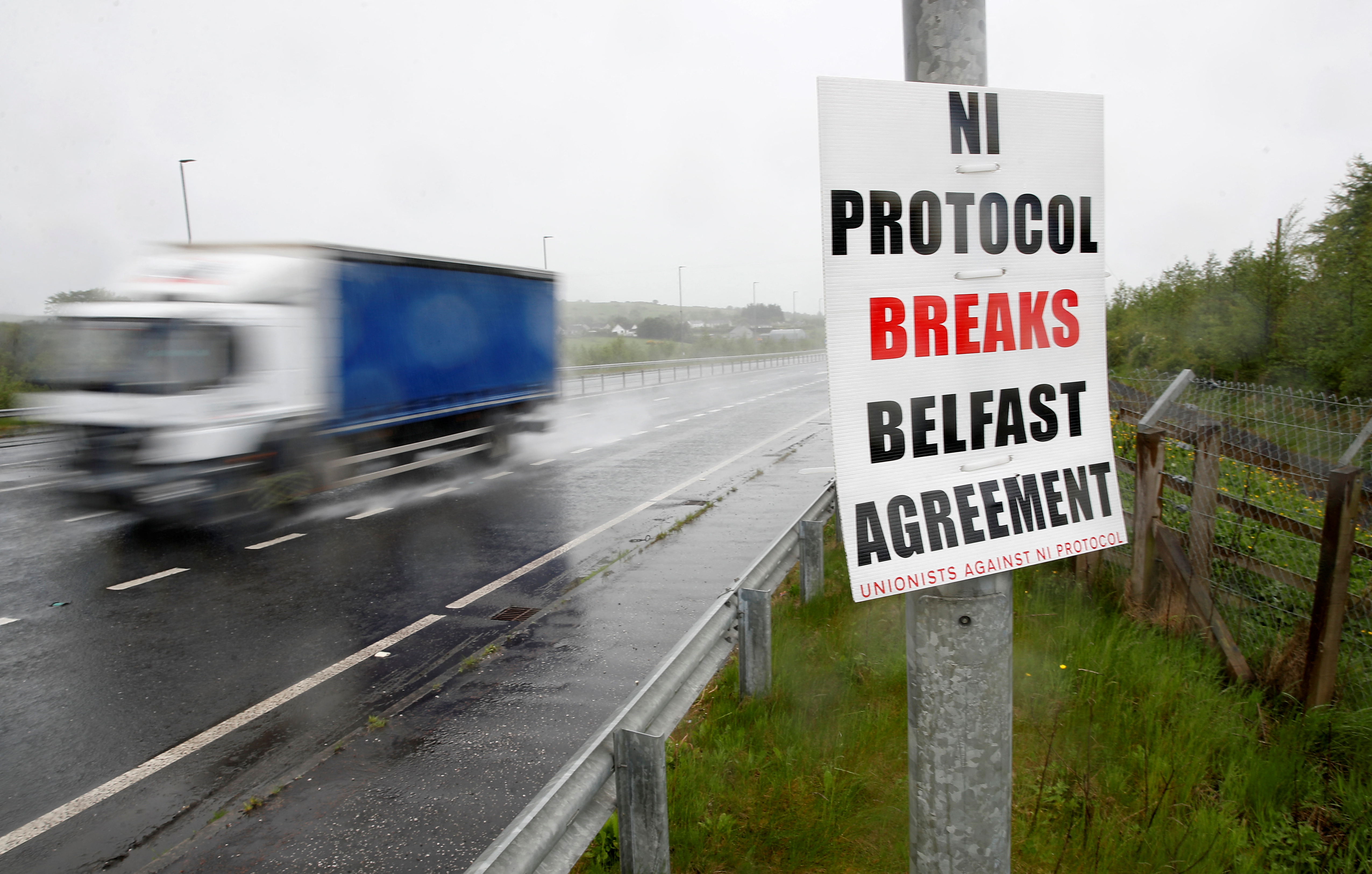An anti-northern Ireland protocol poster is seen next to a road approaching Larne