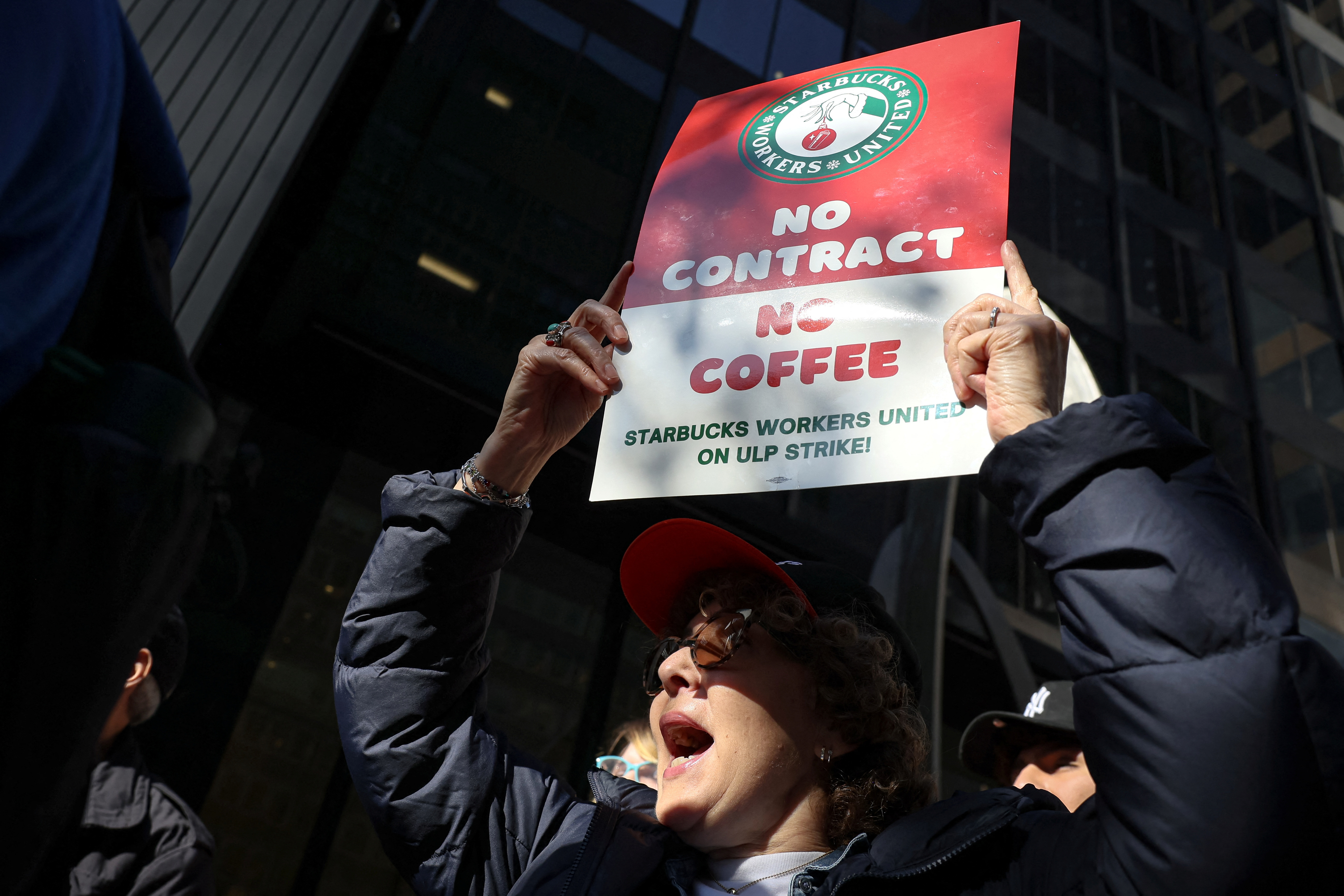 Members of the Starbucks Workers Union picket and hold a rally outside Starbucks store in New York