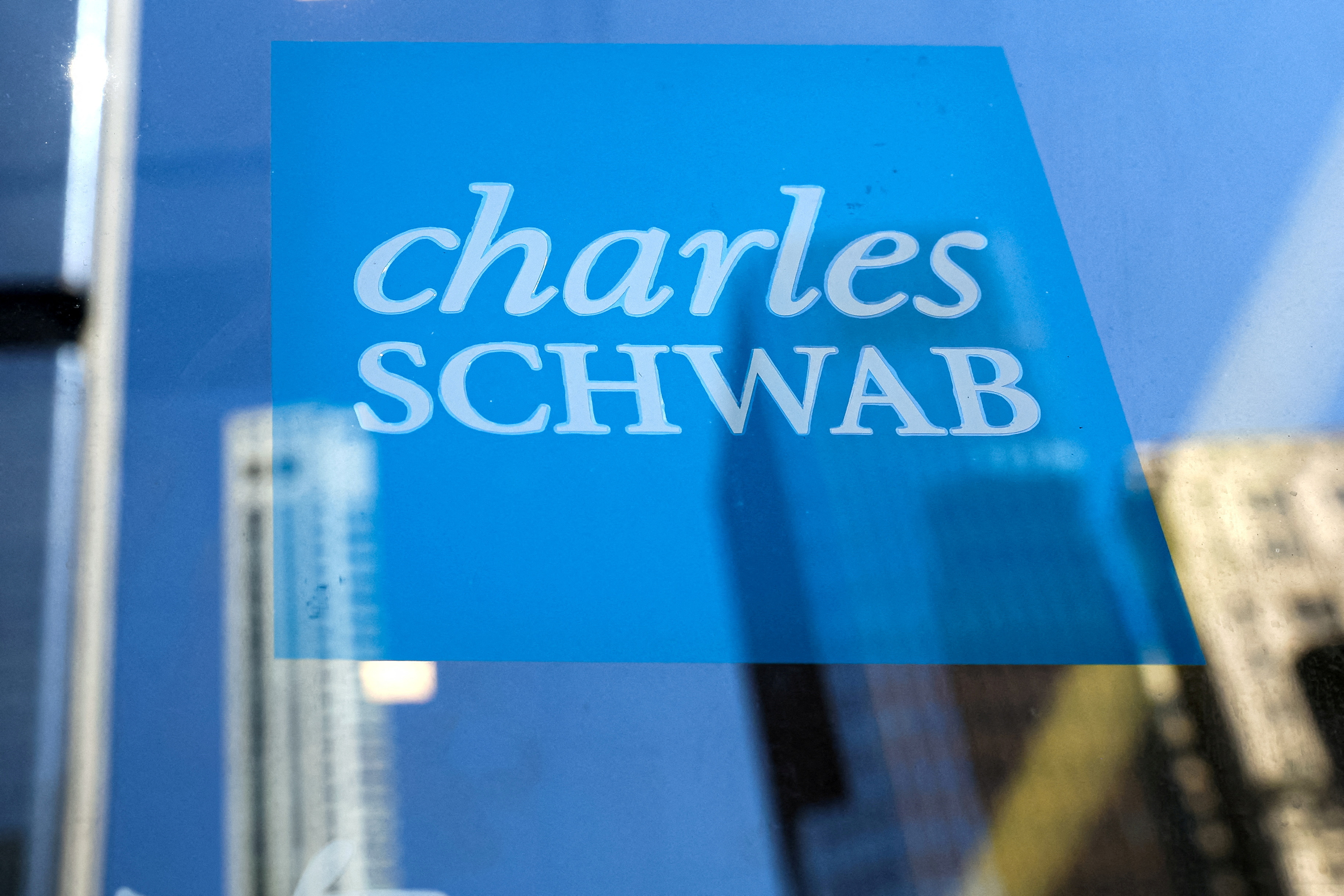 The company logo for financial broker Charles Schwab is displayed at a location in the financial district in New York