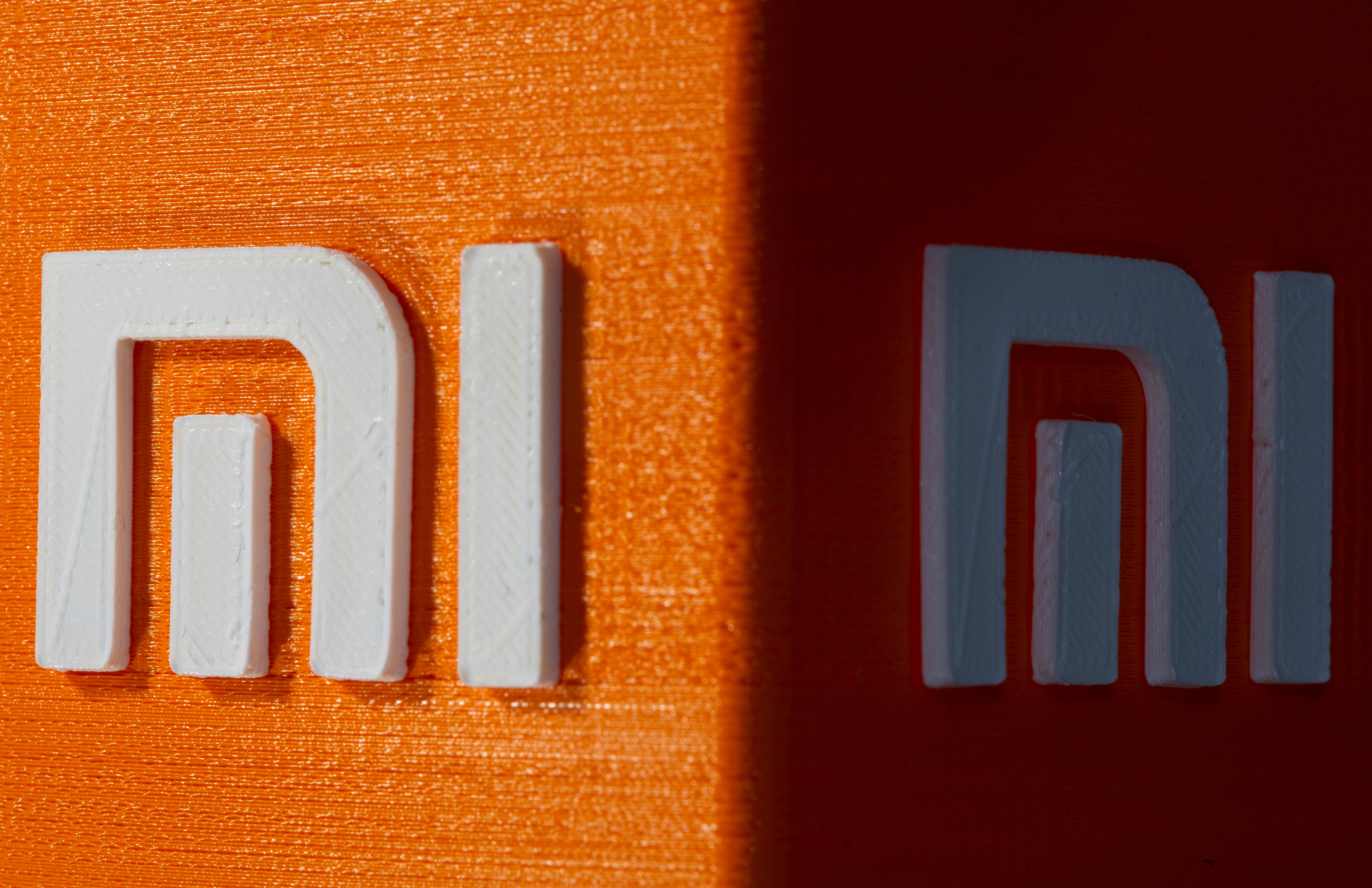 A 3D printed Xiaomi logo is seen in this illustration taken