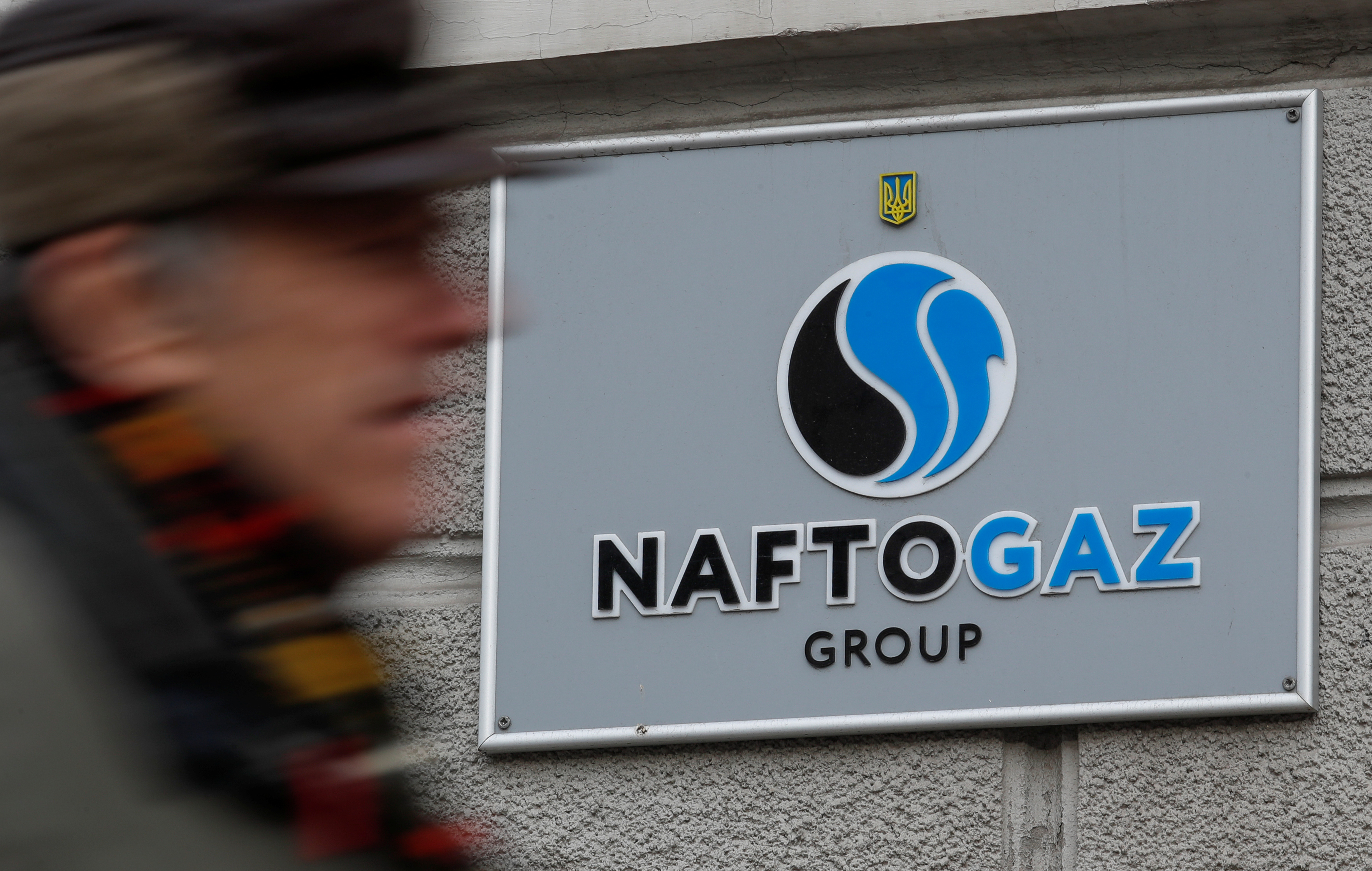 A man walks past Naftogaz headquarters in Kiev