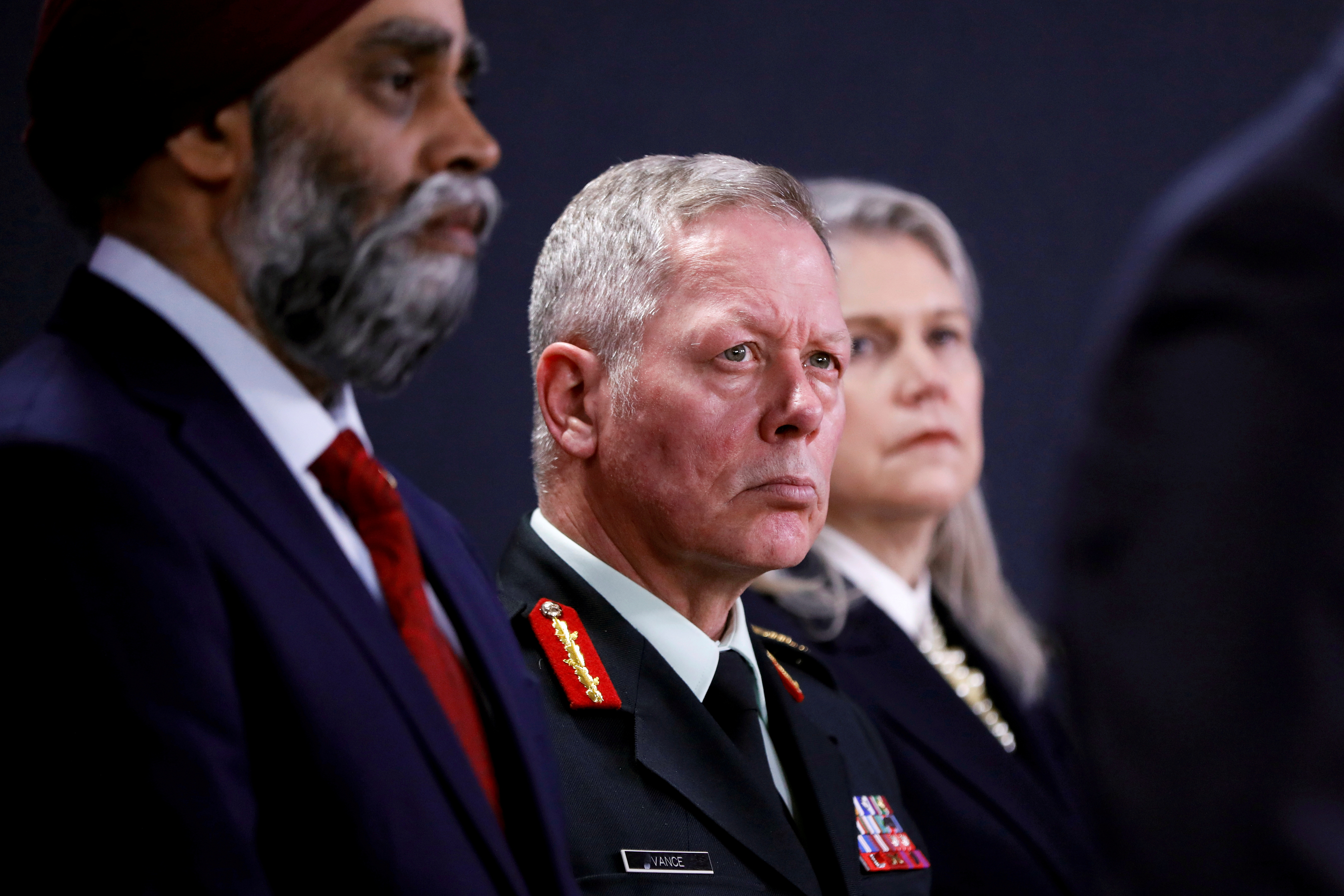 Canada's Chief of the Defence Staff General Jonathan Vance, between Minister of National Defence Harjit Sajjan and Deputy Minister of National Defence Jody Thomas, attends a news conference in Ottawa