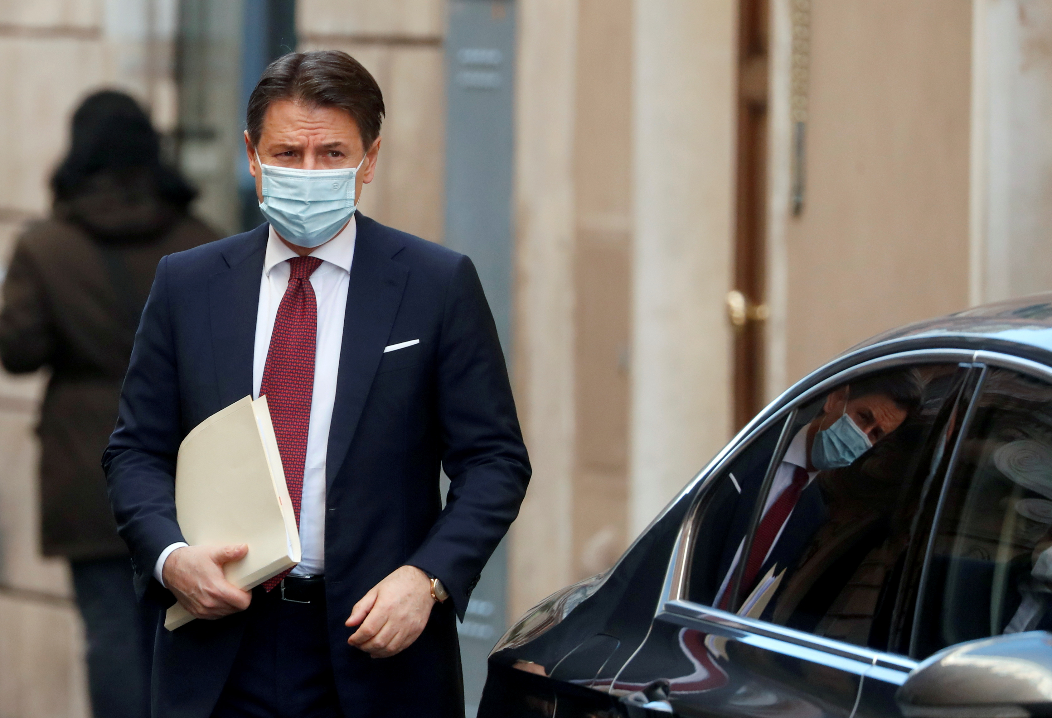 Italy's caretaker Prime Minister Giuseppe Conte leaves his house