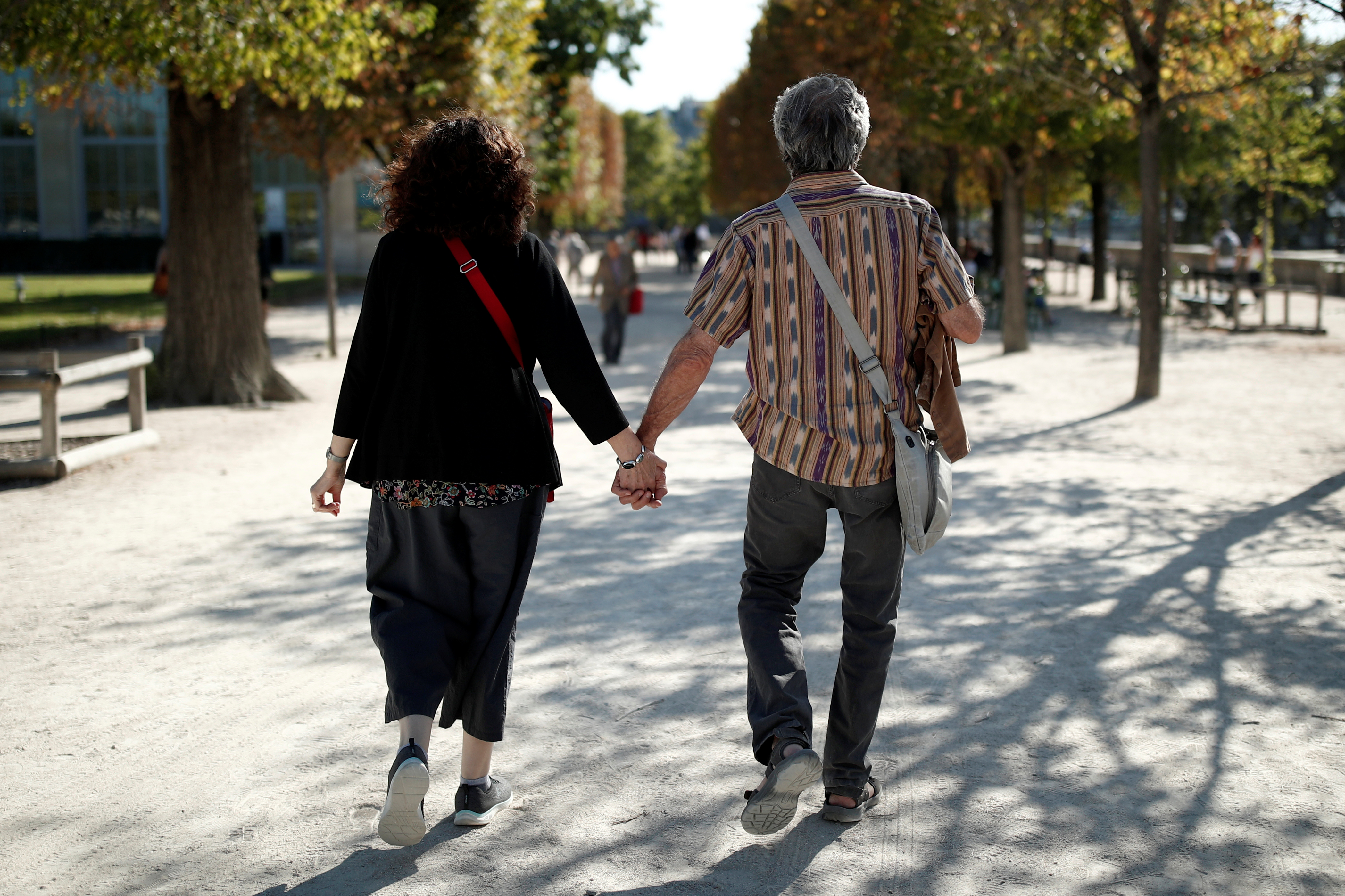 A couple of elderly people walks in the Tuileries Garden in Paris, France, September 2, 2019. REUTERS/Benoit Tessier