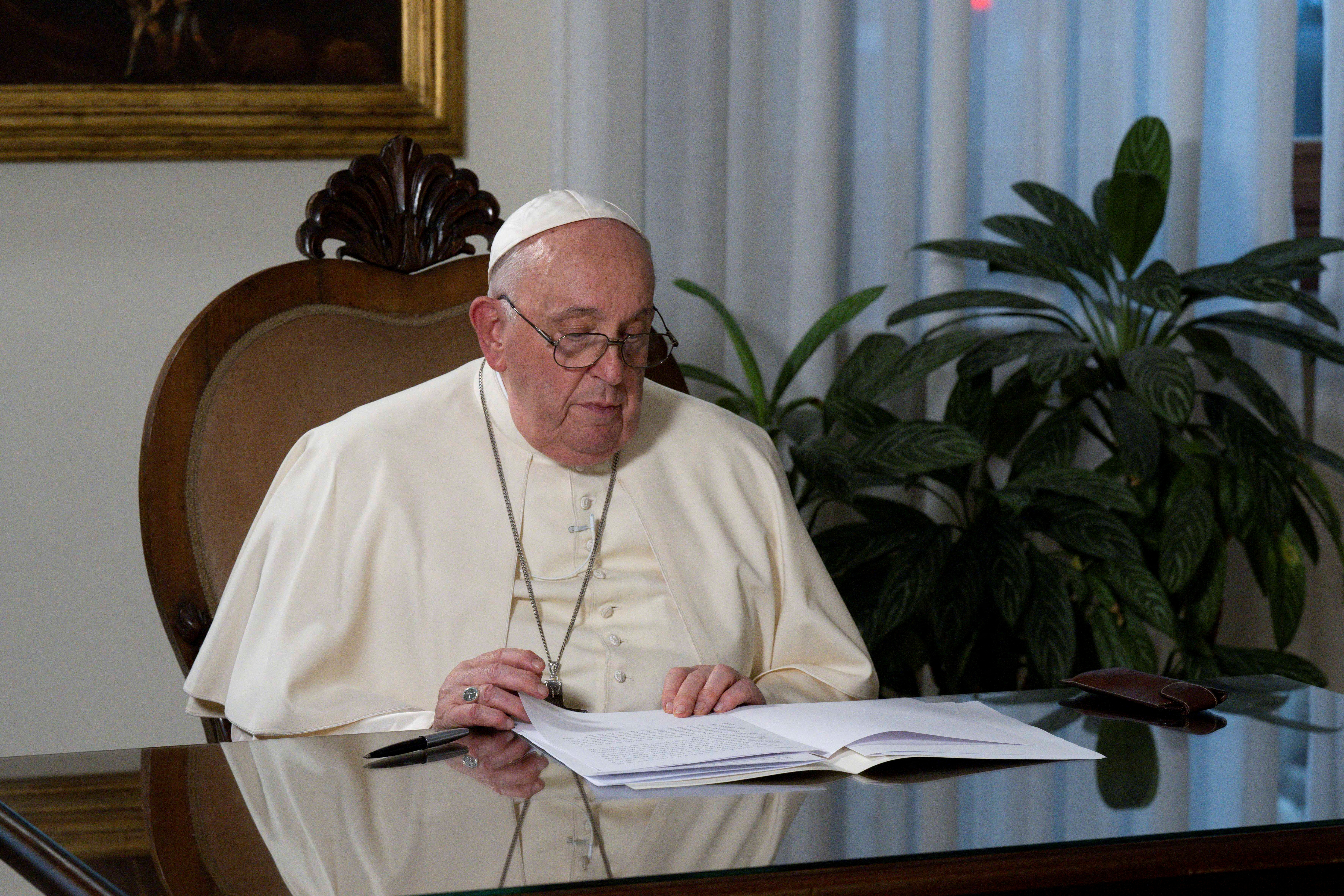 Pope Francis signs a unified faith declaration on climate action as part of the inauguration of the "Faith Pavilion" during COP28 in Dubai, at Casa Santa Marta