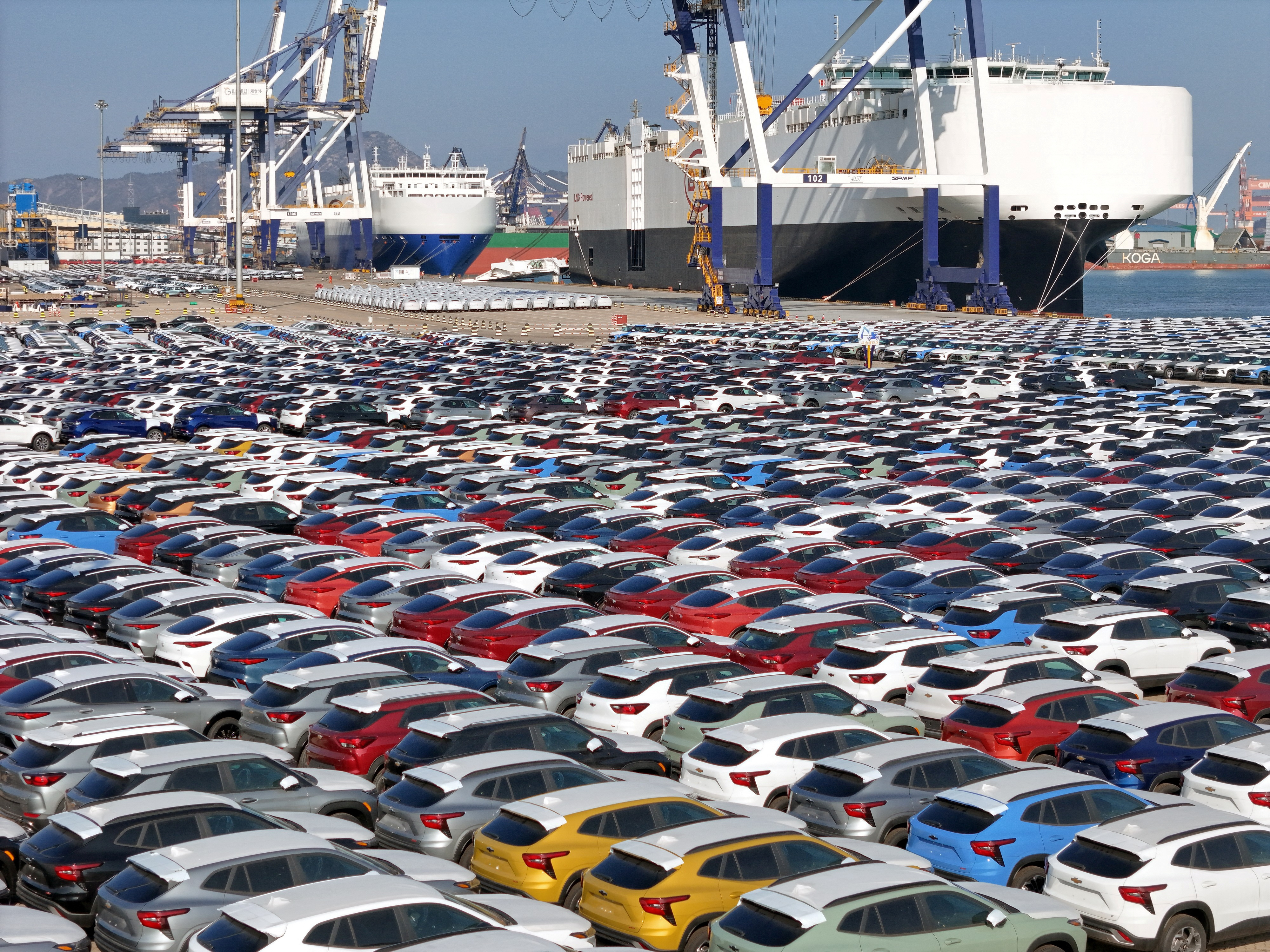 Cars to be exported sit at a terminal in the port of Yantai