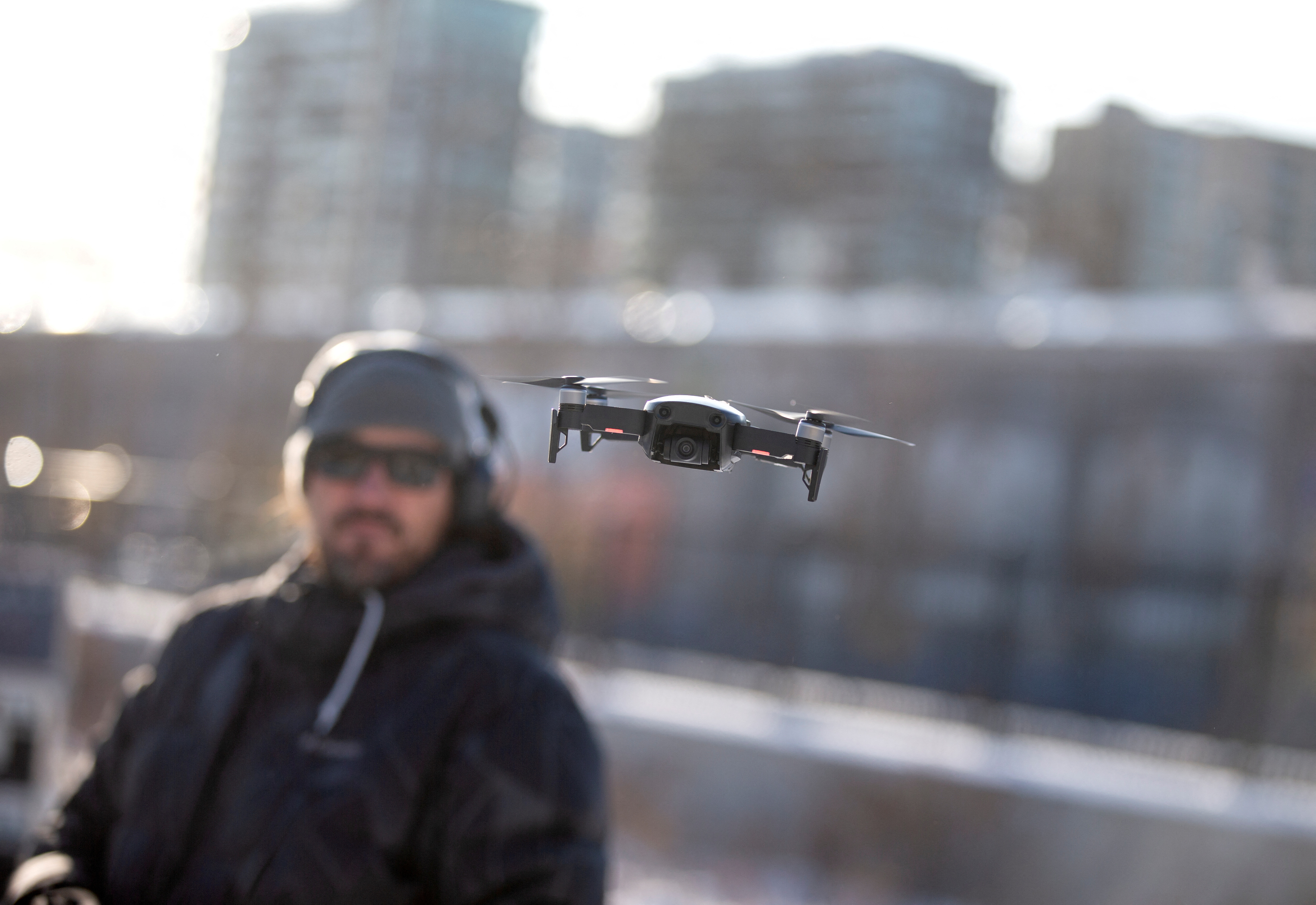A drone operator flies his drone as Chinese drone maker DJI holds a demonstration to display an app that tracks a drone's registration and owner in Montreal