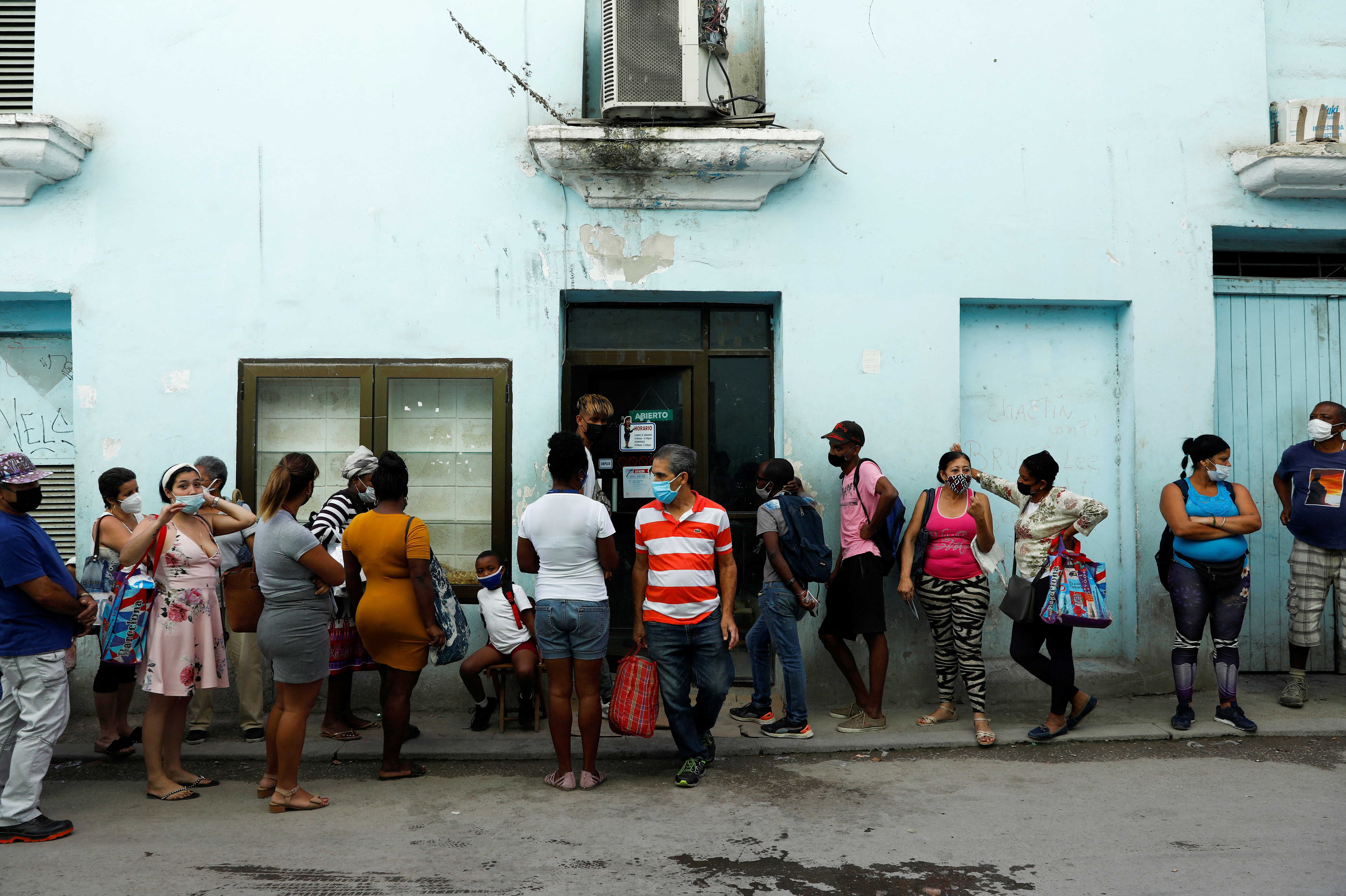 People line up to buy food in downtown Havana