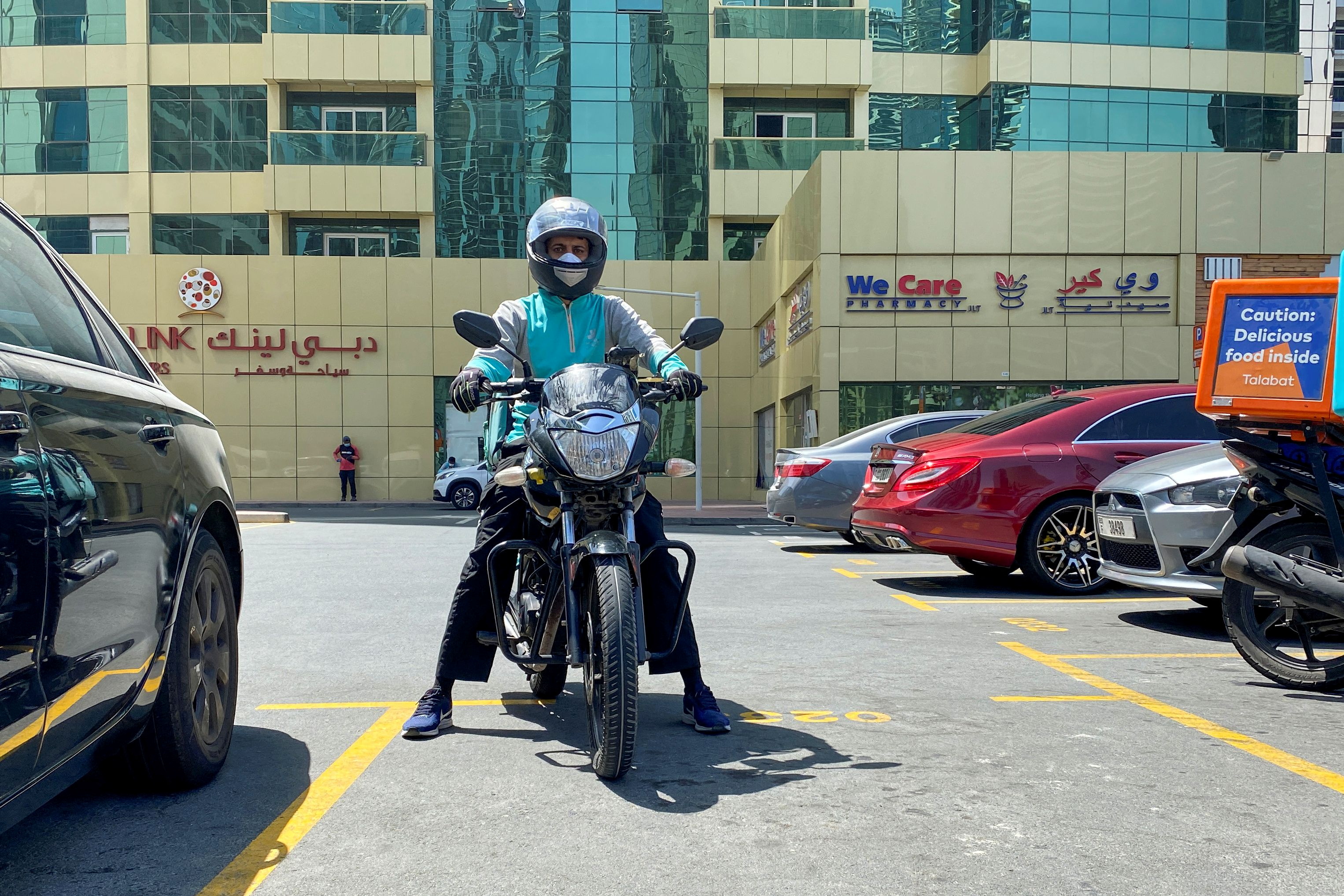A food delivery worker rides a motorbike to deliver meal orders, following the outbreak of the coronavirus disease (COVID-19), in Dubai