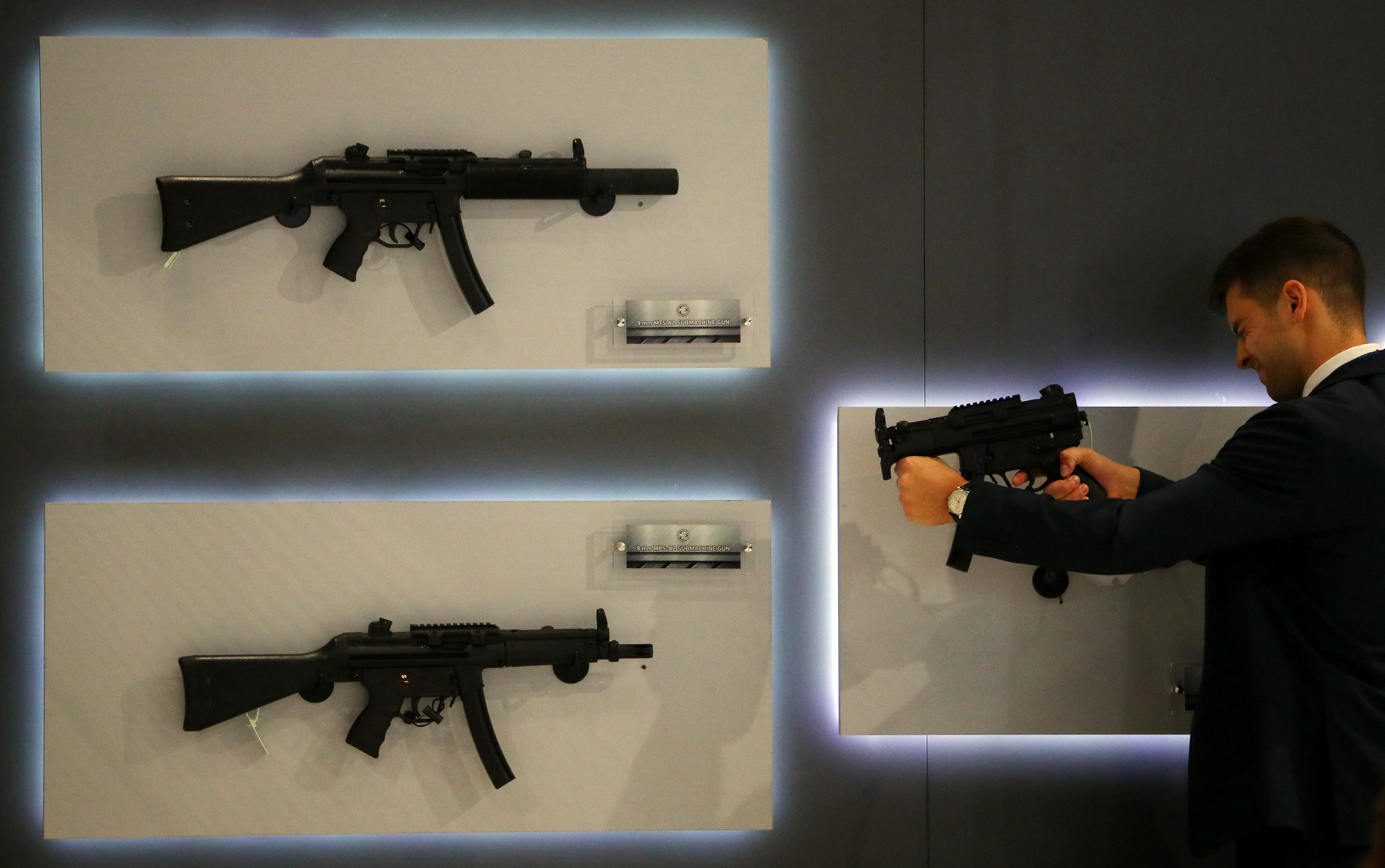 A visitor looks at an MP5K sub-machine gun at the Defence and Security Equipment International trade show in London