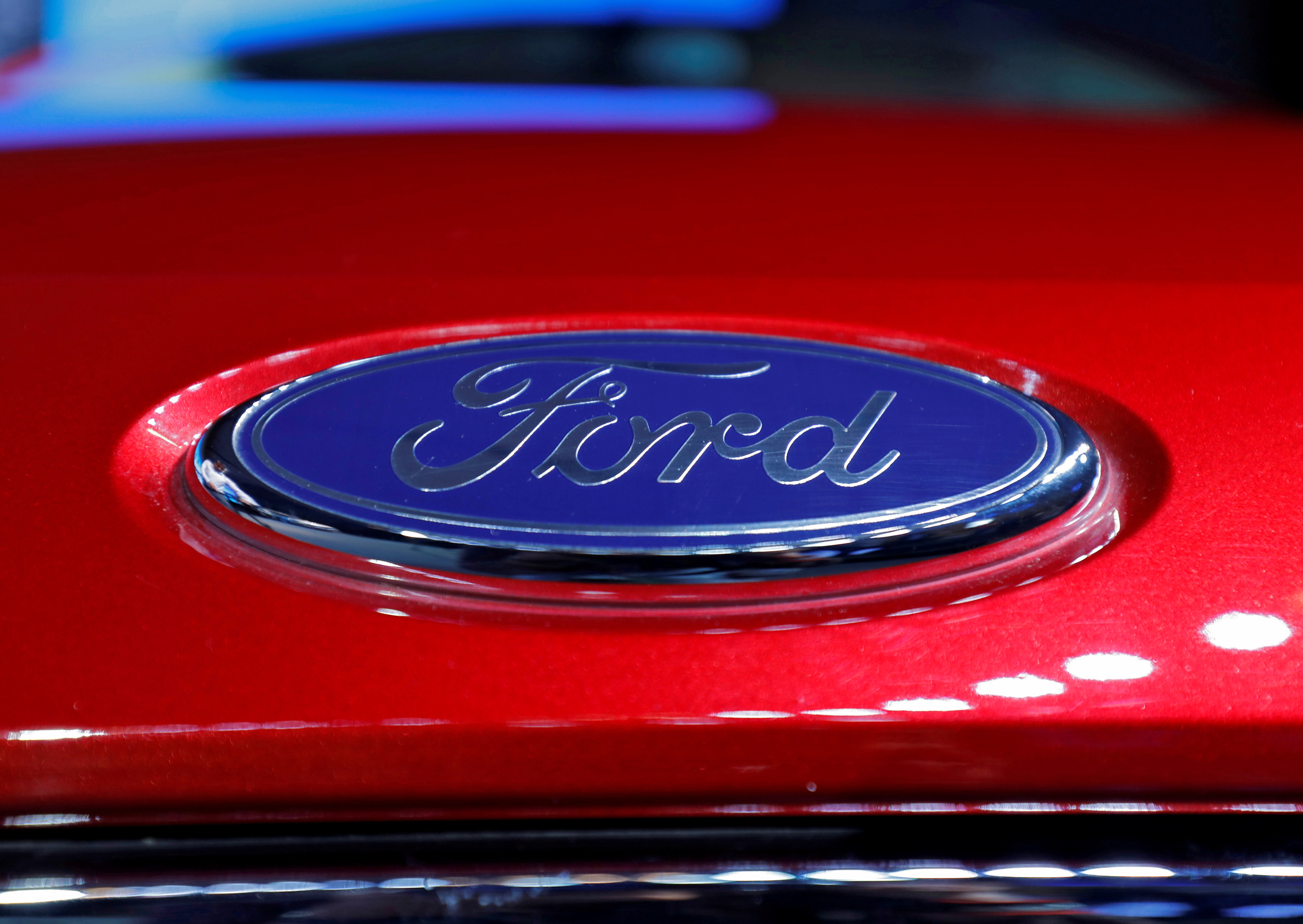 The logo is seen on the bonnet of a new Ford Aspire car during its launch in New Delhi