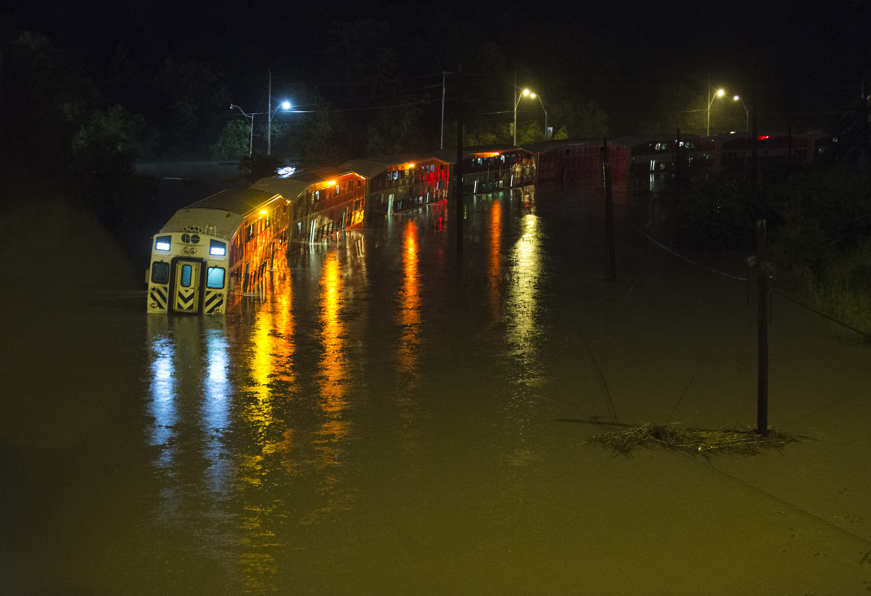 A Go Train, a commuter train, with passengers waiting to be rescued inside, is stuck in flood waters during a heavy rainstorm in Toronto, July 8, 2013.    REUTERS/Mark Blinch