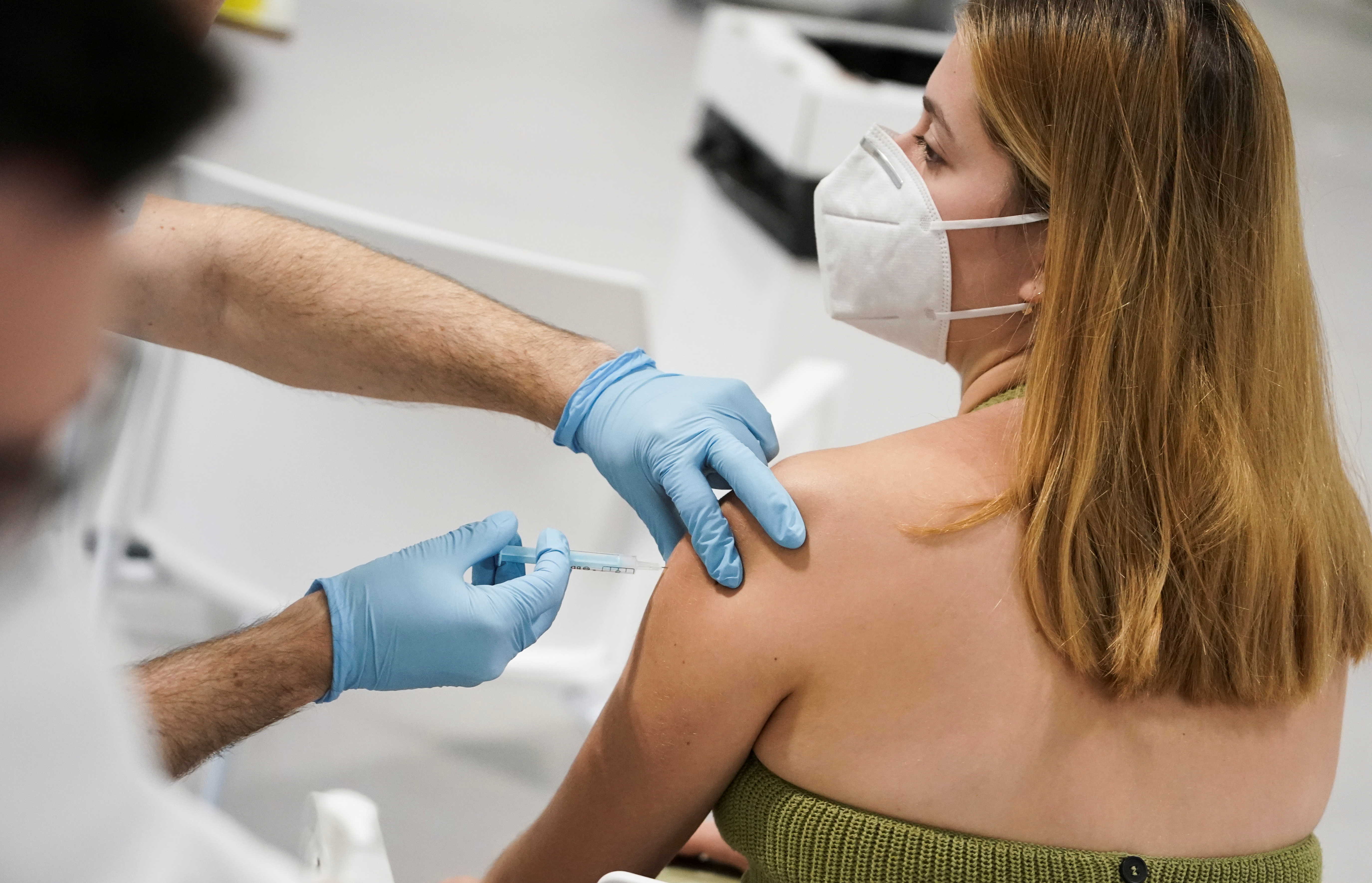 A woman receives a dose of the Moderna coronavirus disease (COVID-19) vaccine in Madrid